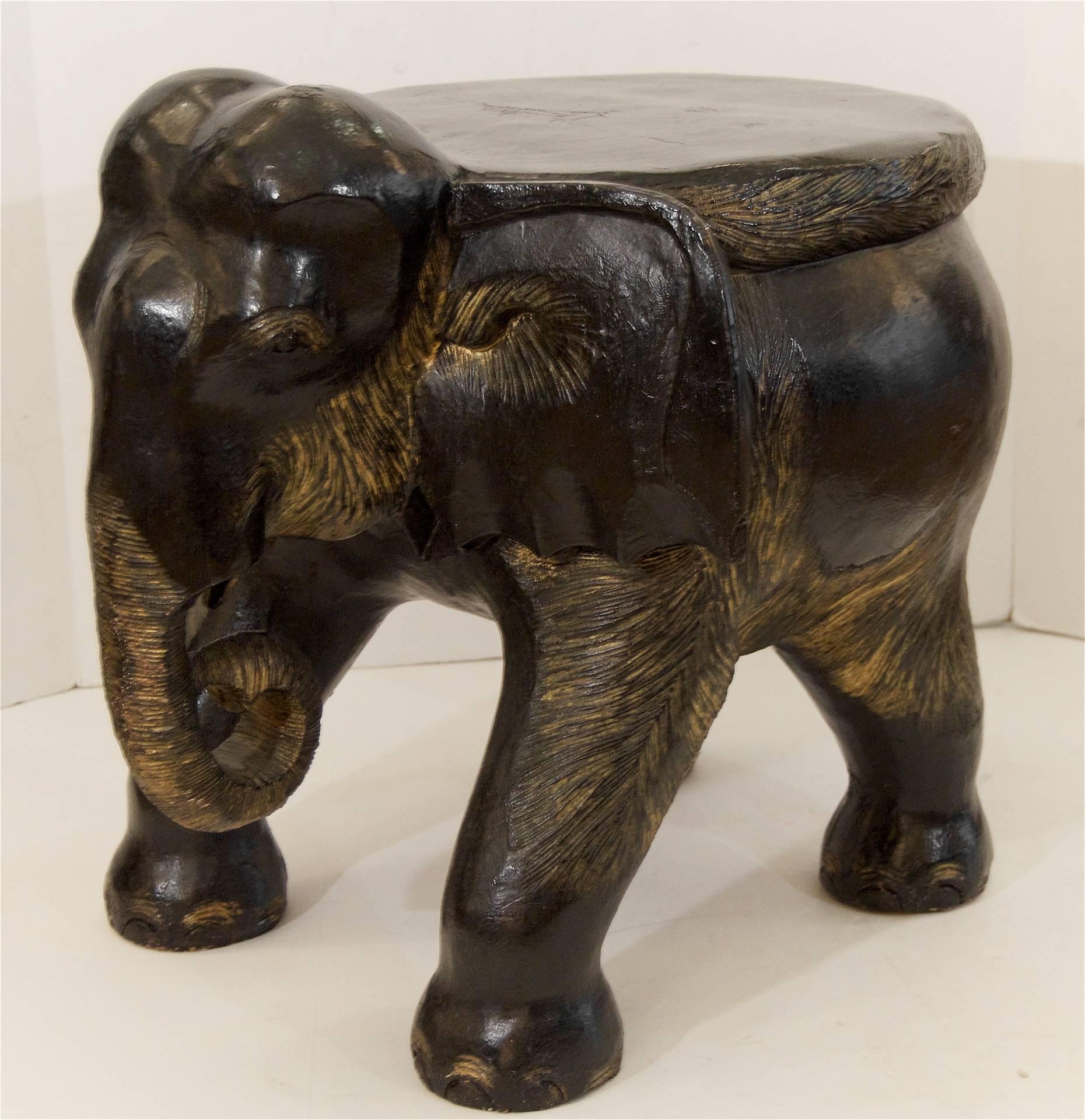Ebonized elephant stool with carved detailing, and painted gold accents.
May also be used as an occasional table.
 