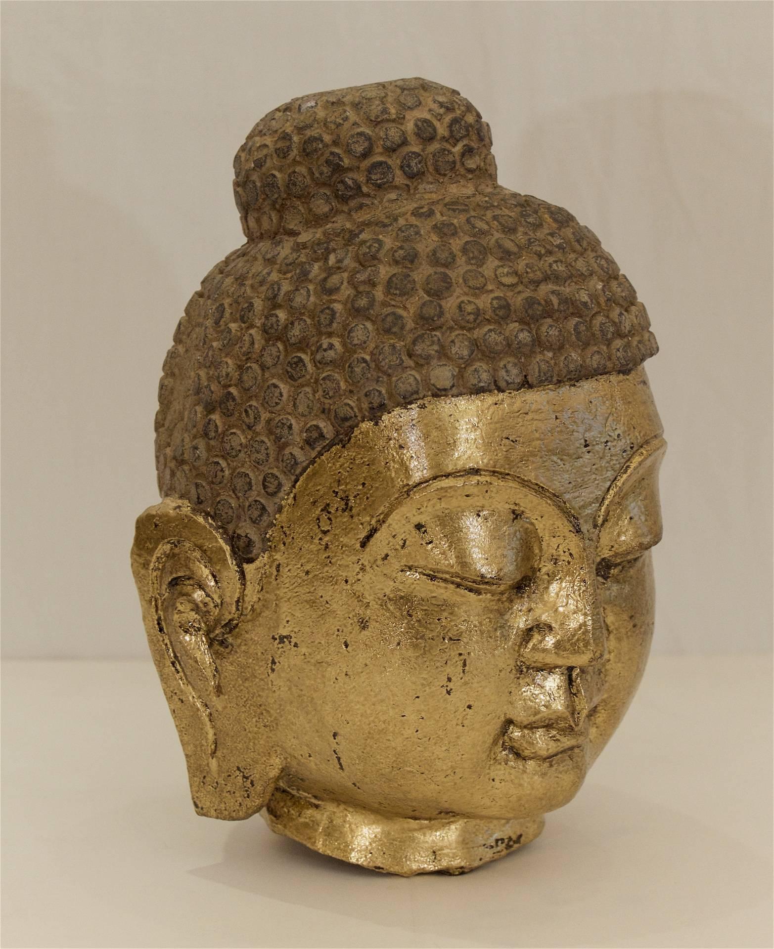 Excellent Buddha head of carved stone with recently gilt face.

Uncertain age of creation, no later than early 20th century.