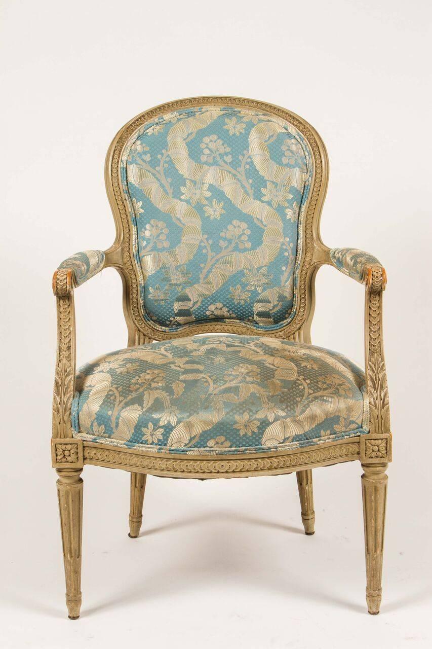 A George III style open armchair, with Classic reeded legs, down-swept padded arm supports, and splayed rear legs. Upholstered in Silk Lampas. This armchair would be lovely in a bedroom at a desk.