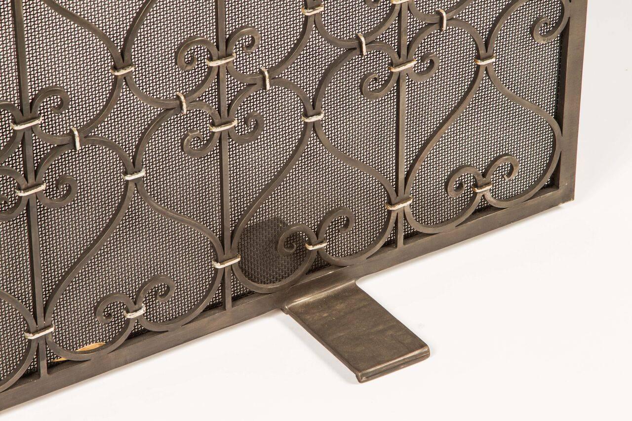 Classic and elegant in design, this fire screen has stunning silver accents. Two rear handles allow for ease of mobility. It would be wonderful in a rustic or Mediterranean design aesthetic.