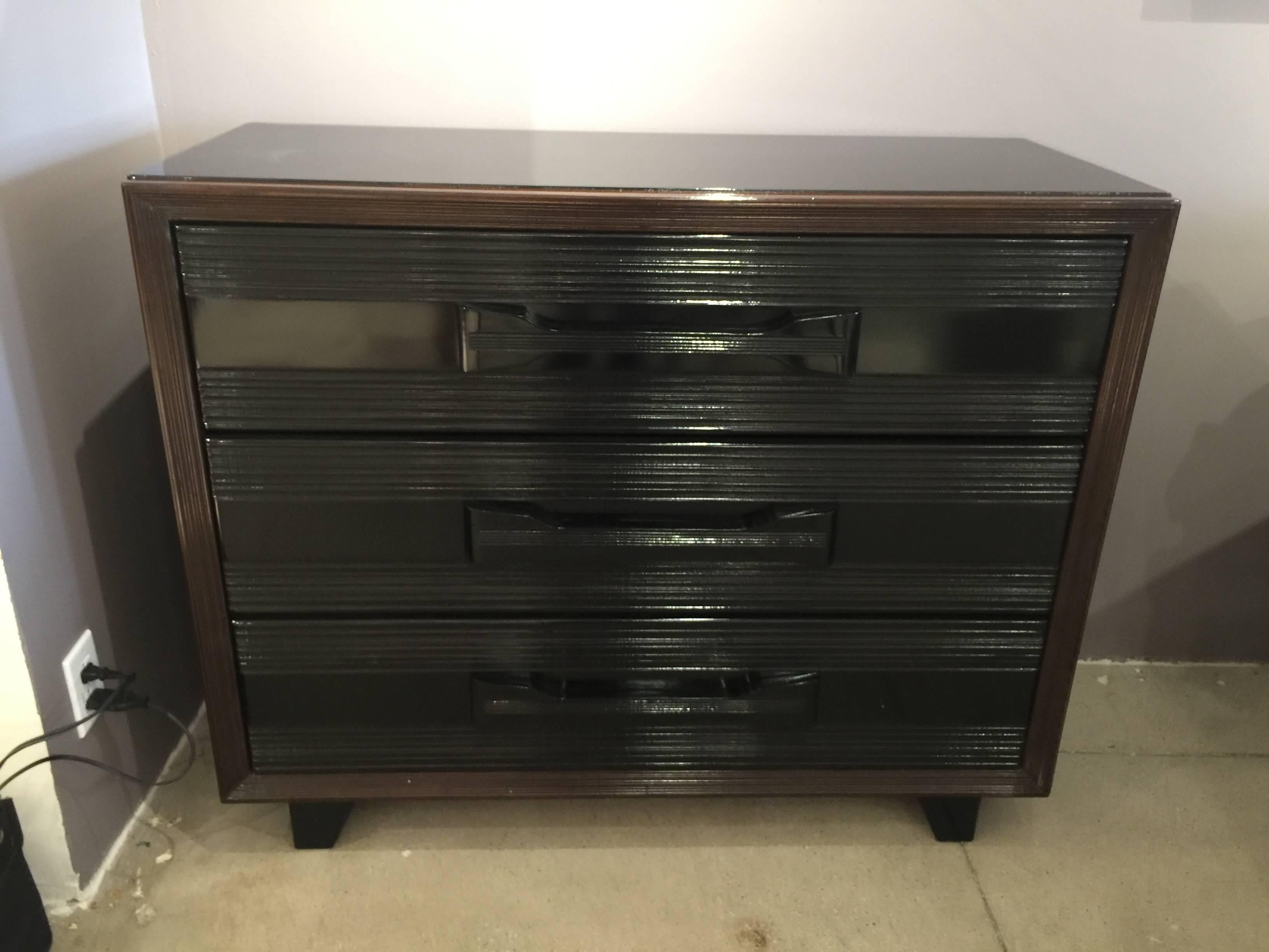 Three large drawers (top one with removable dividers) with Art Deco streamlined design and finished with piano quality lacquer black with deep mahogany brown trim. These are a pair.