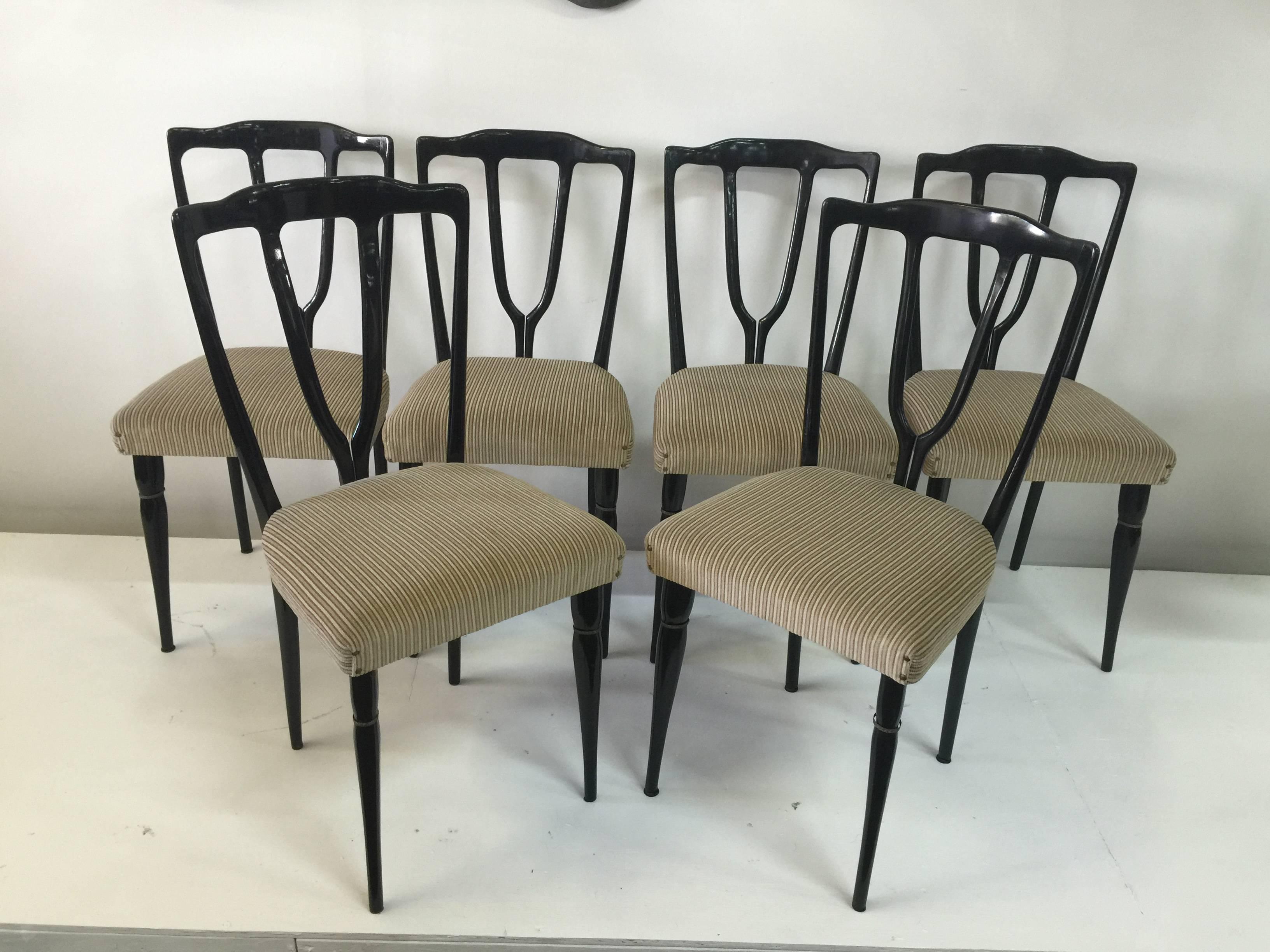 All original, these black lacquered wood framed chairs with wish-bone detail to backrest, have an additional touch of detail with brass rings to the legs. 

Note: Just arrived and will ship from our Miami showroom.