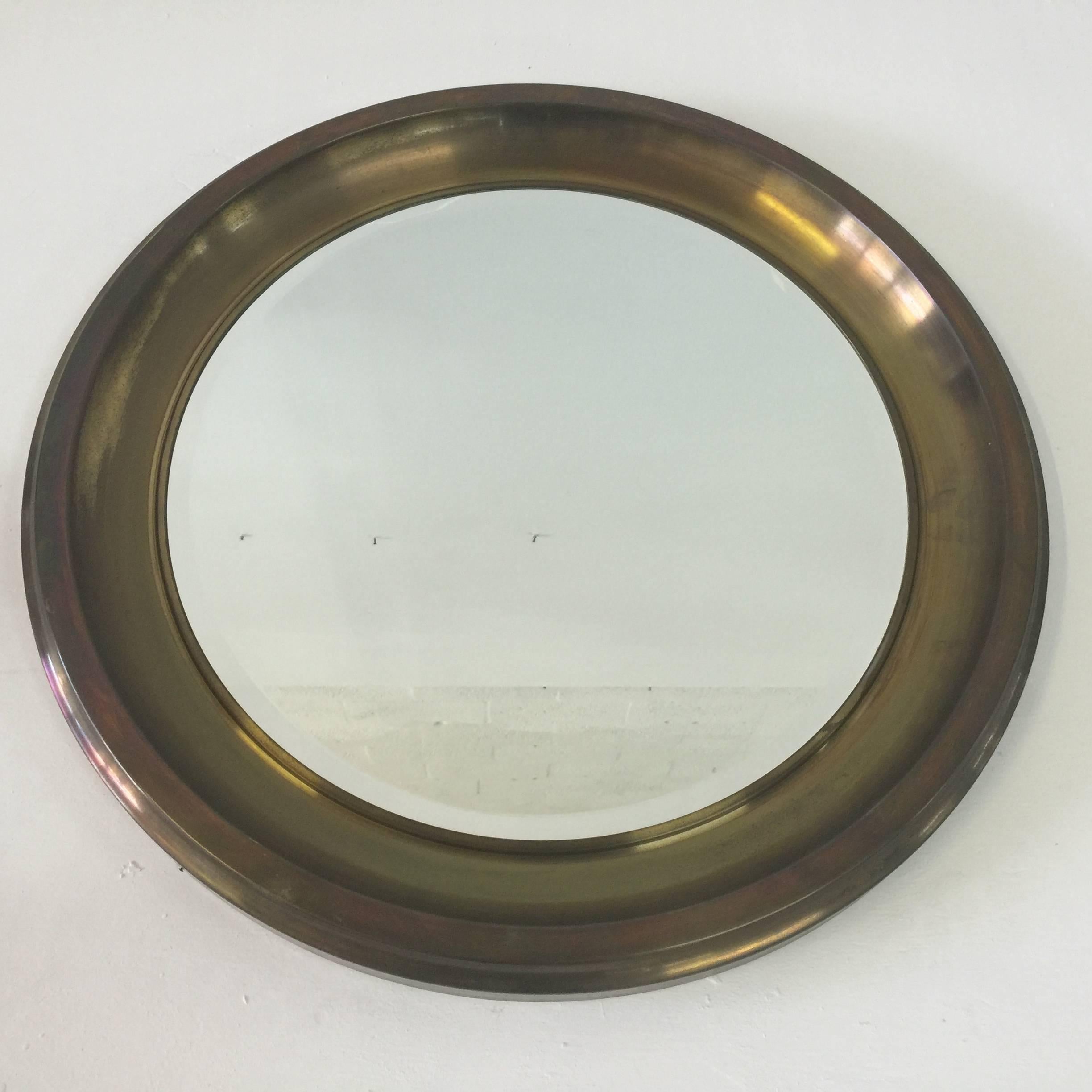 Beautiful dark bronze patina on this large molded brass circular mirror by Sergio Mazza for Artemide.