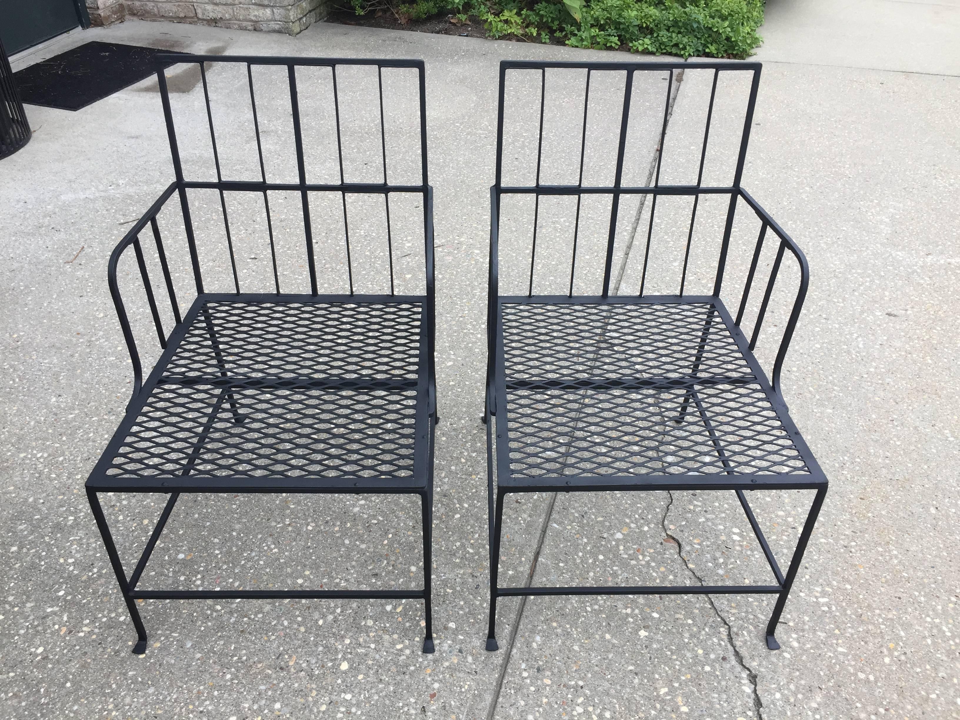 These are a sleek matte black pair of iron chairs with a simple white seat cushion. You can add a splash of fun in your choice of back pillow yourself! Details abound from the feet to the simple Art Deco design.