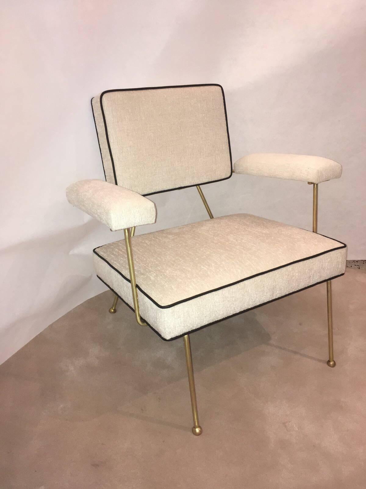 Beautiful all brass frame, this armchair with clean lines and finished in creamy chenille fabric and leather trim. This is a pair of low chairs. 

Note: A matching set of ottomans are also available for purchase separately.