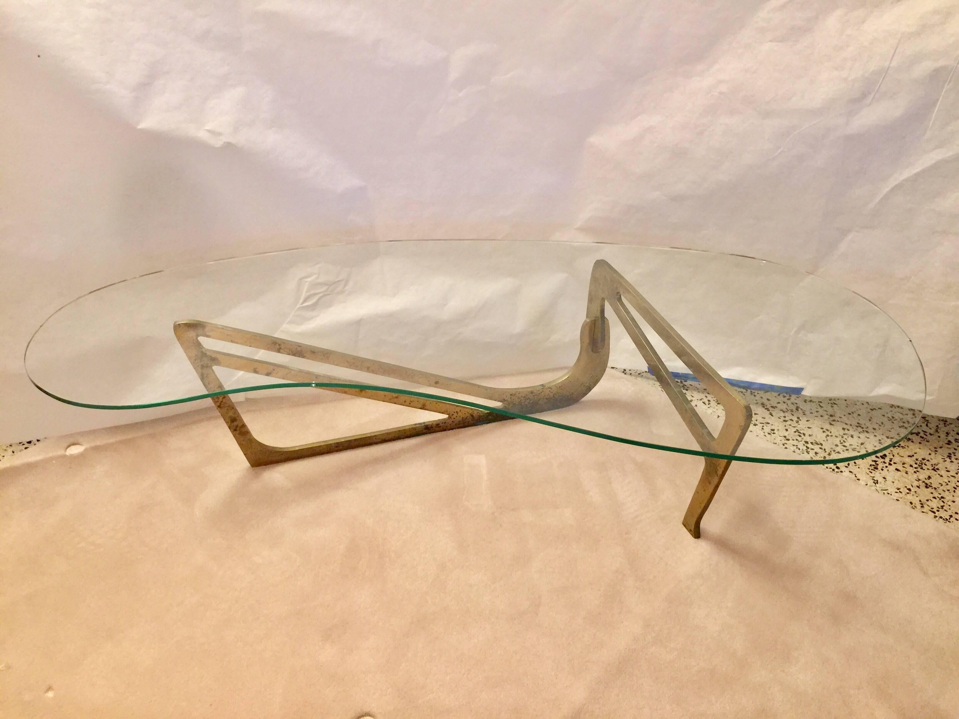Rare stencil cut design in solid brass, very sculptural with original biomorphic glass top and the base is comprised of two parts interconnected. This is all original, glass has some chips and the base has patina/pitting that can be polished to