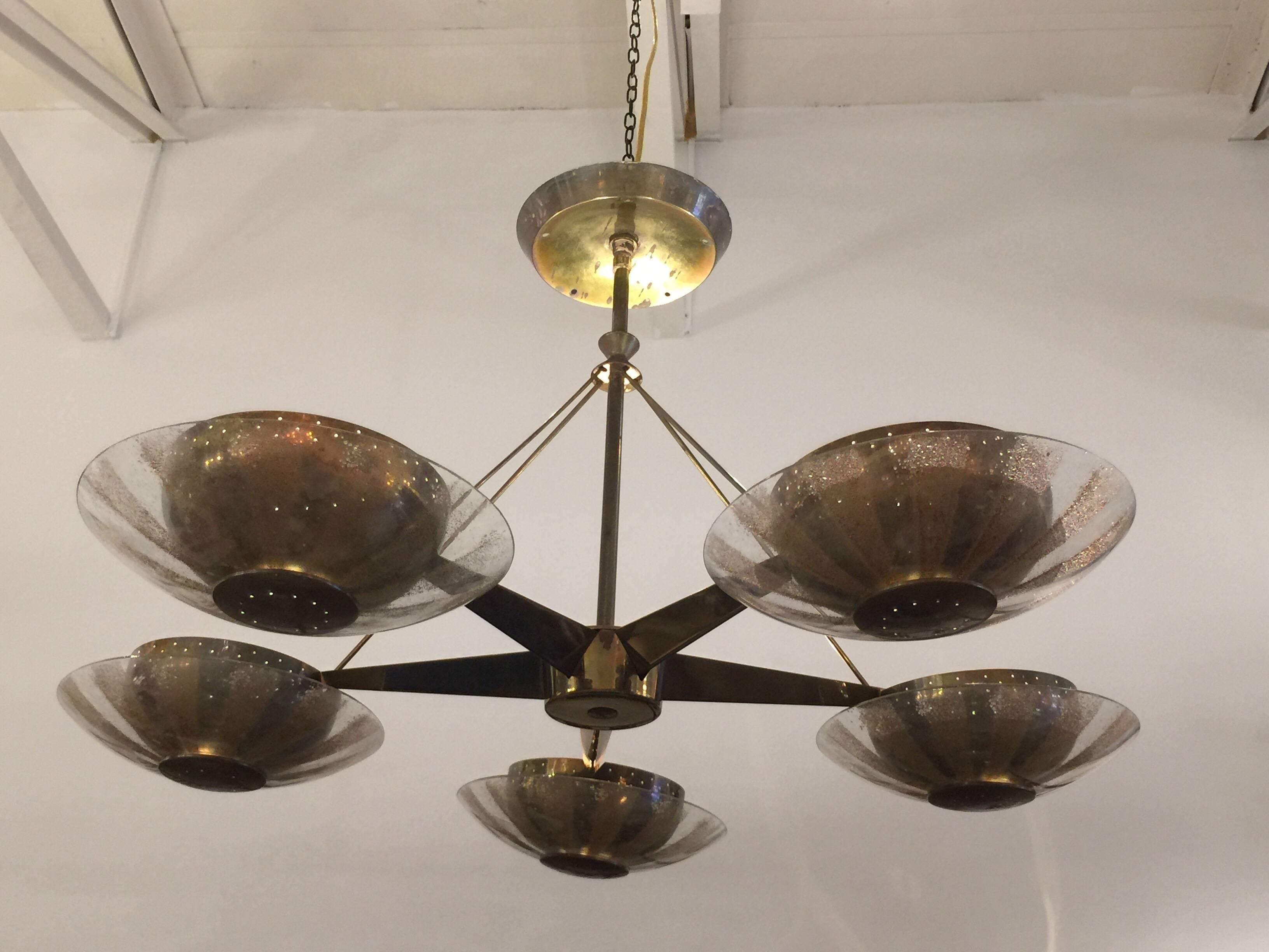 Stunning and romantic, this five-arm chandelier in star design with beautifully patinated brass. Each arm has a perforated brass cup and glass difuser with gold flake design. This is all original and in wonderful working condition, rewired.