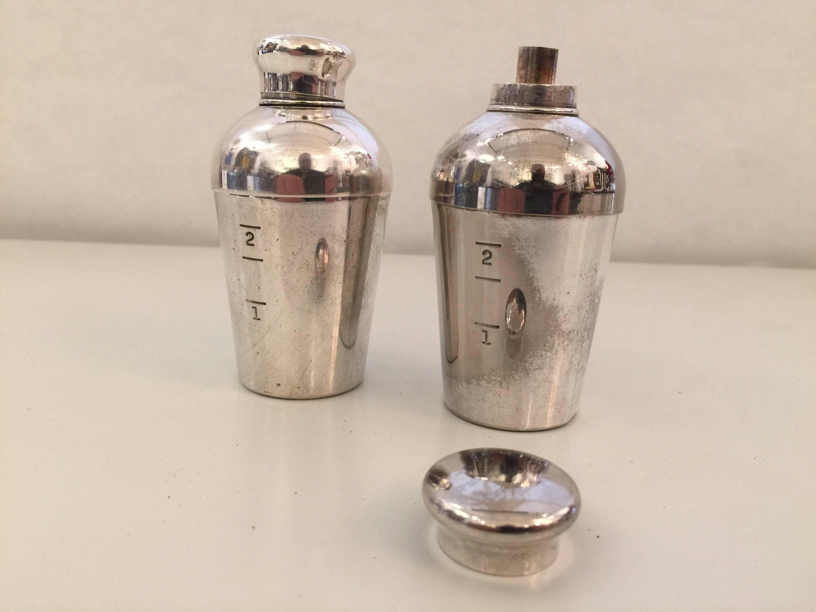 Incredibly cute and useful miniature cocktail shakers by Napier Co. In the Art Deco style and made of silver plate, the tops come off for mixing and can also be used as travel-sized shot glass.