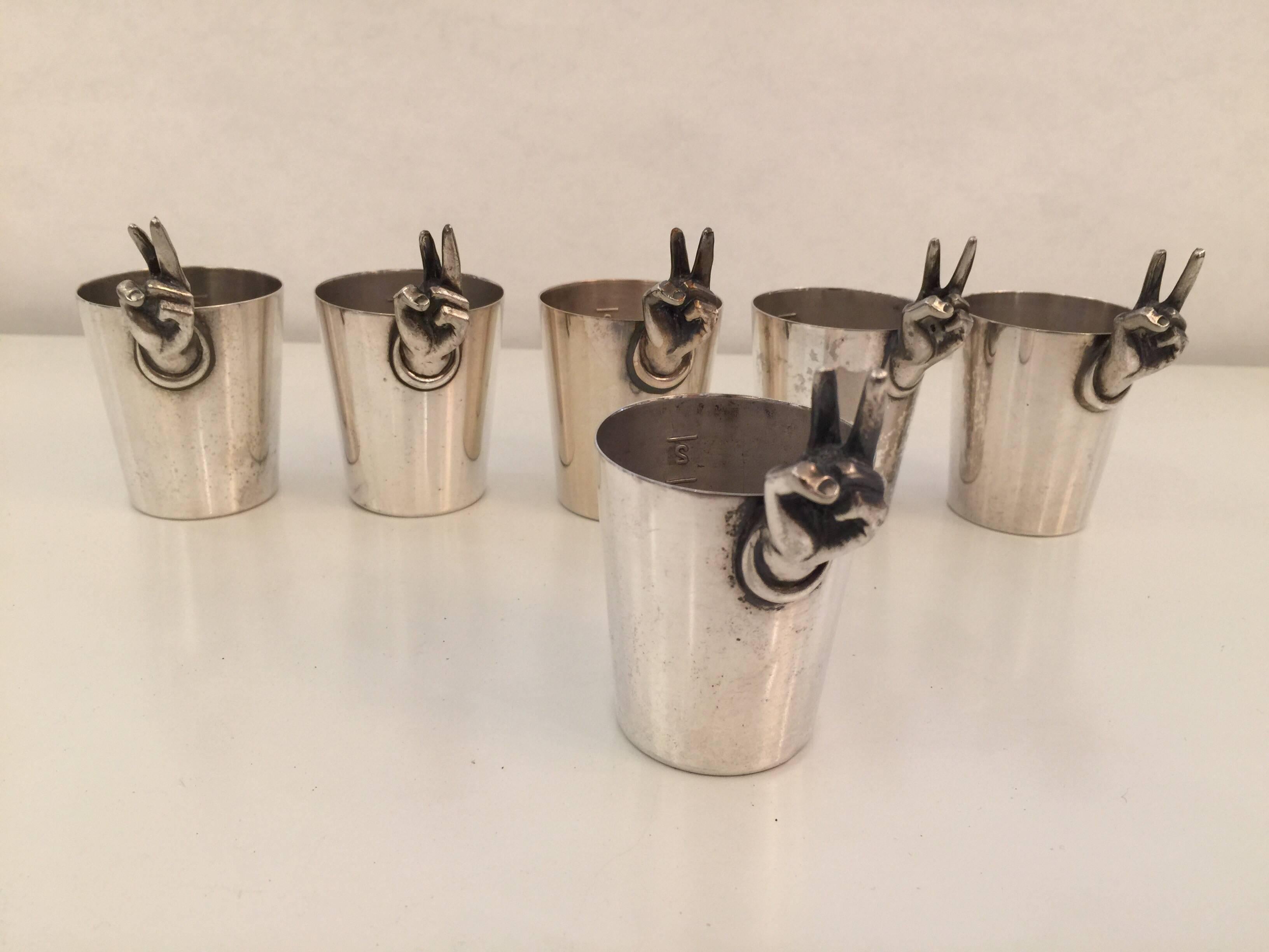 This is a rare and whimsical set of six shot glasses with 