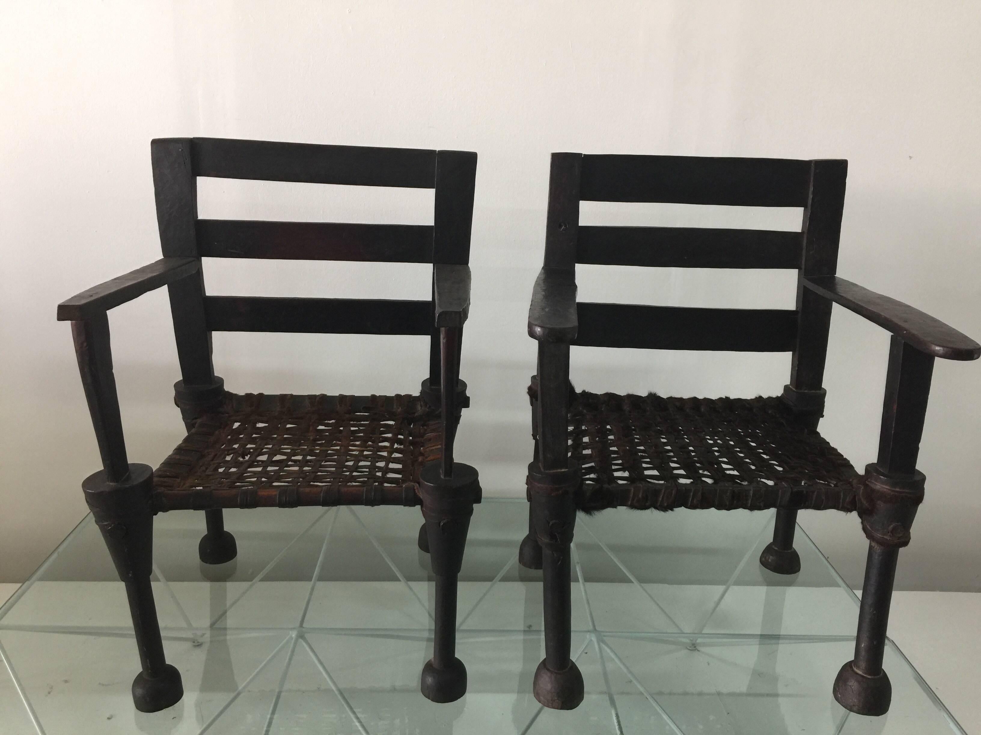These fantastic King and Queen chairs are highlighted by a exceptional patina and detailed with incredible carvings and hand-stitched animal hide seat. Great pair for collectors or modern home decor.

H 36.5 in. x W 26.5 in. x D 19 in.