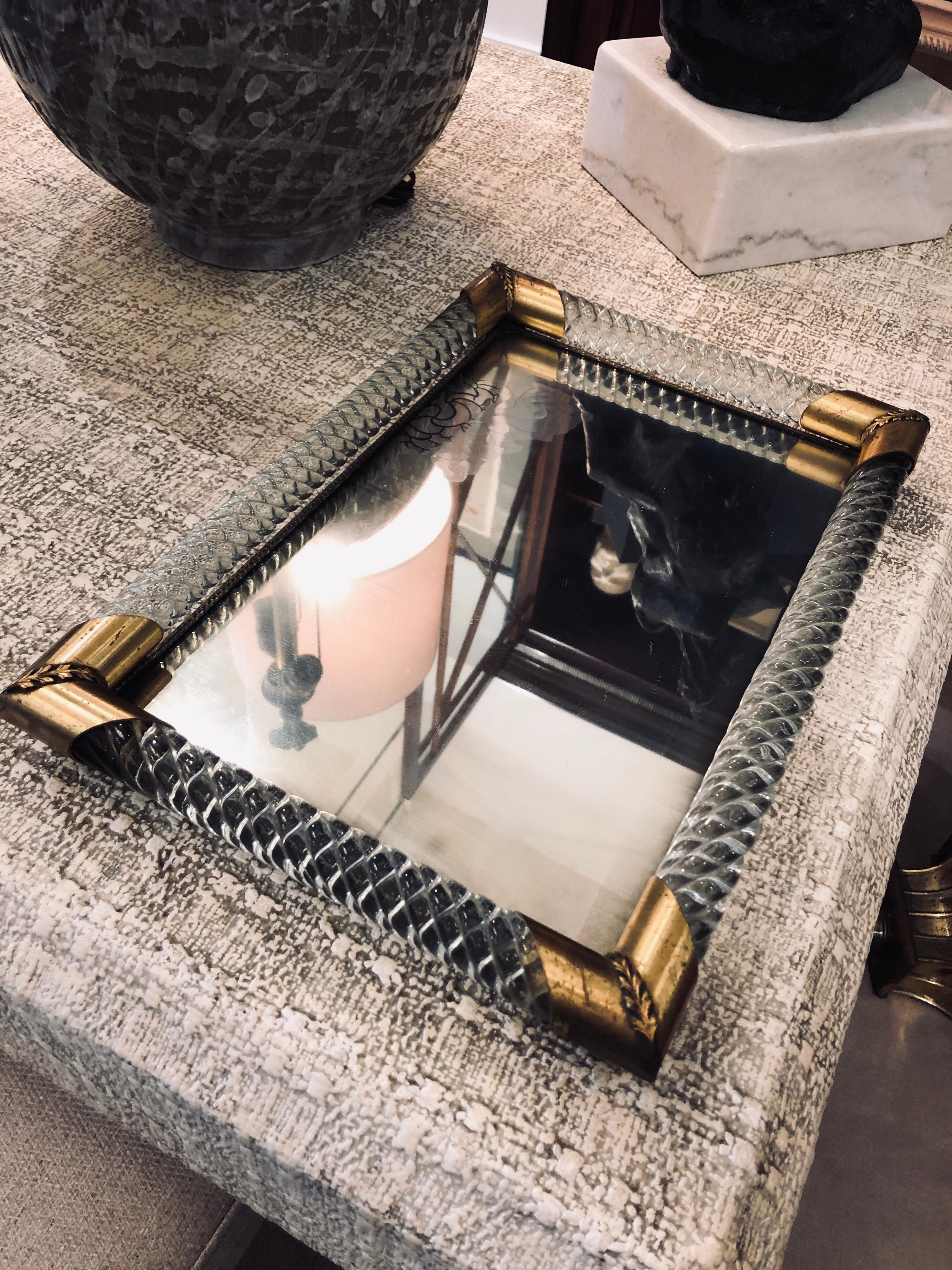Large in scale with brass corner accents and twisted Murano glass design. Fantastic ALL original and vintage with patina and original mirror base. Shows crackling and aging throughout mirror and brass.