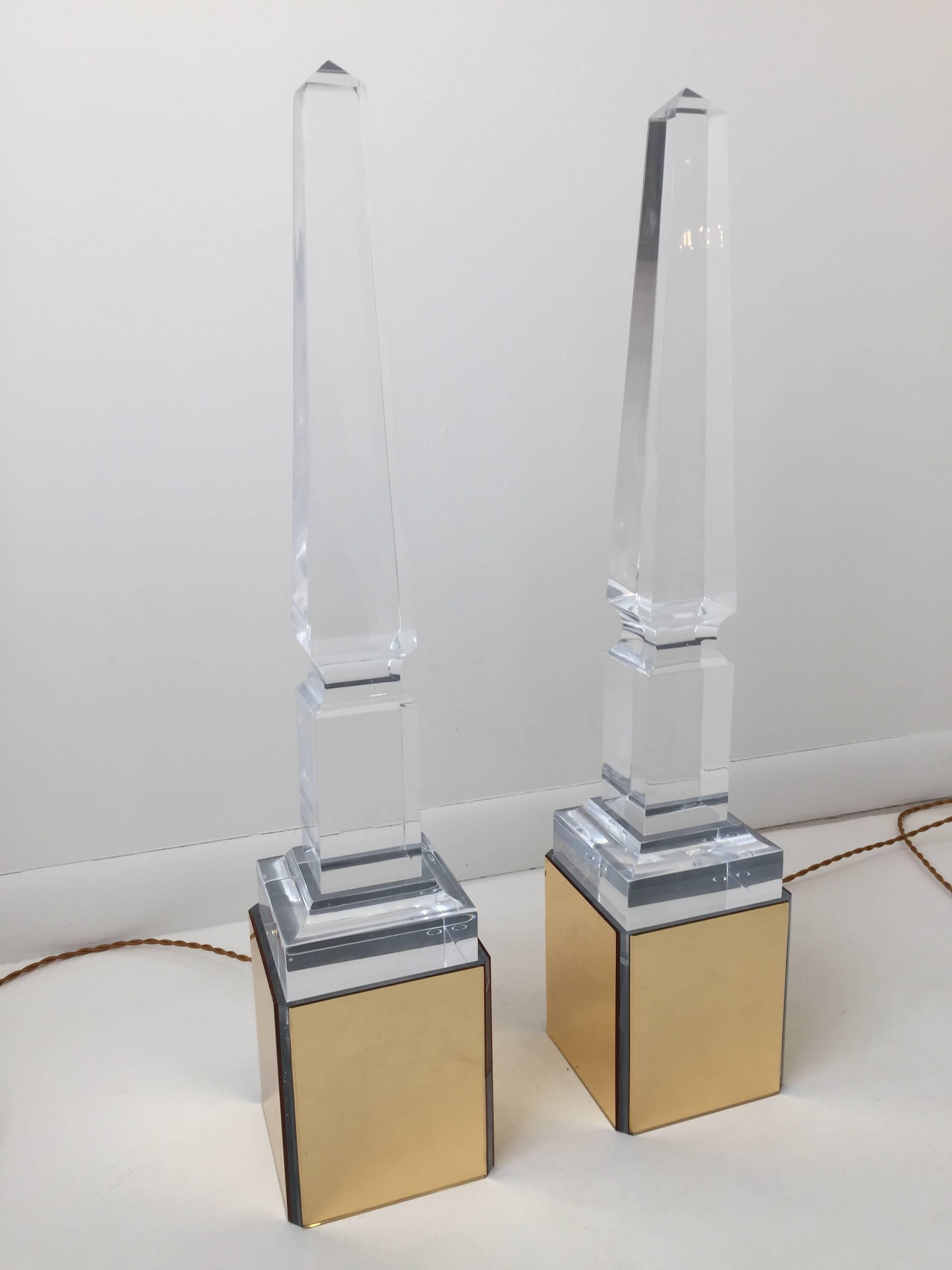 Truly unique all acrylic obelisk monuments on a Lucite light stand which lights from underneath. Provides great ambient lighting through the clarity of the obelisk.