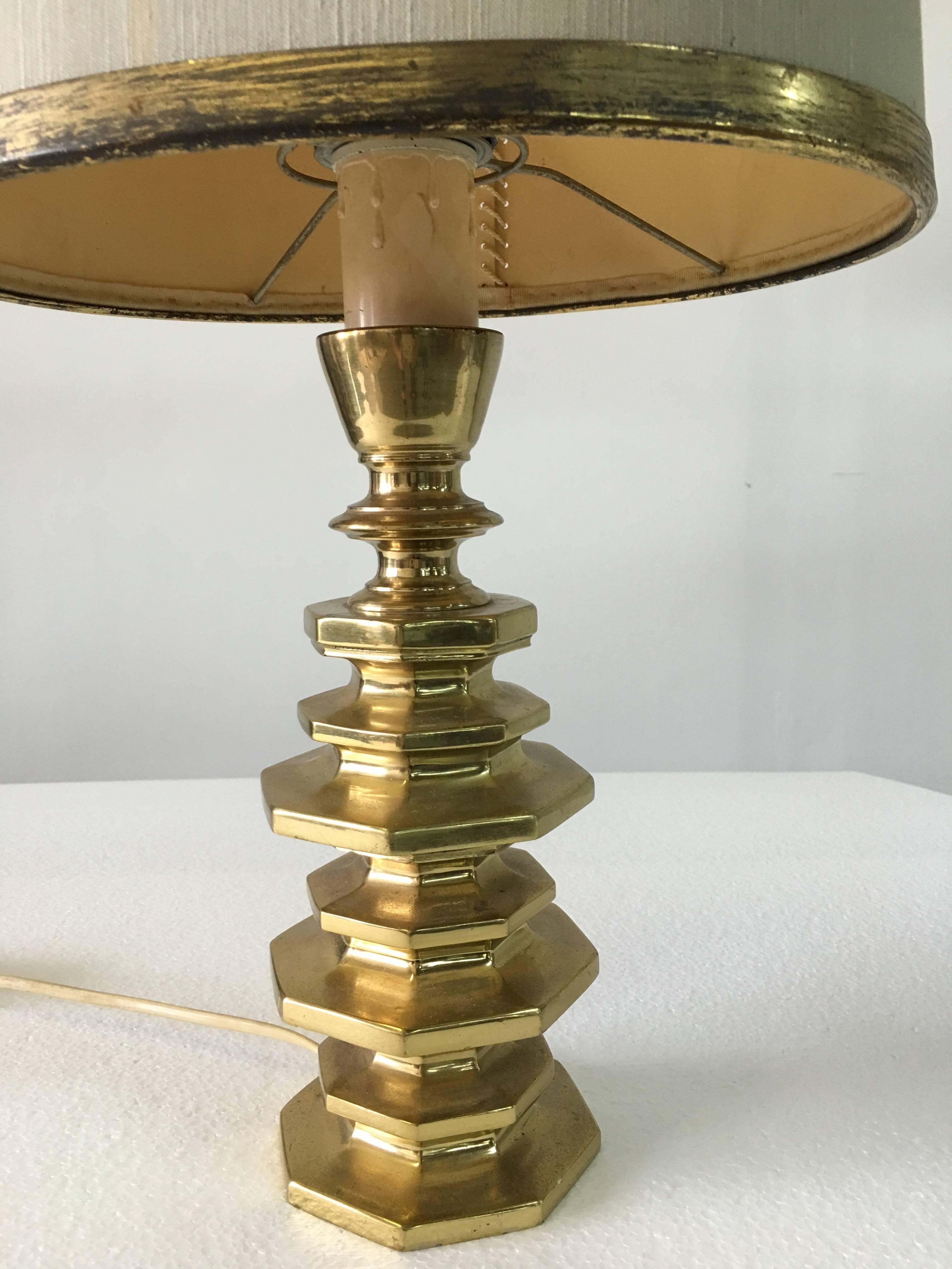 Reminiscent of a pagoda tower, this very heavy solid bronze table lamp has its original brass trimmed shade and intricate stitching to reverse. Has some wear but all vintage and original.  

Base only dimensions: 11.5 inches tall
Shade