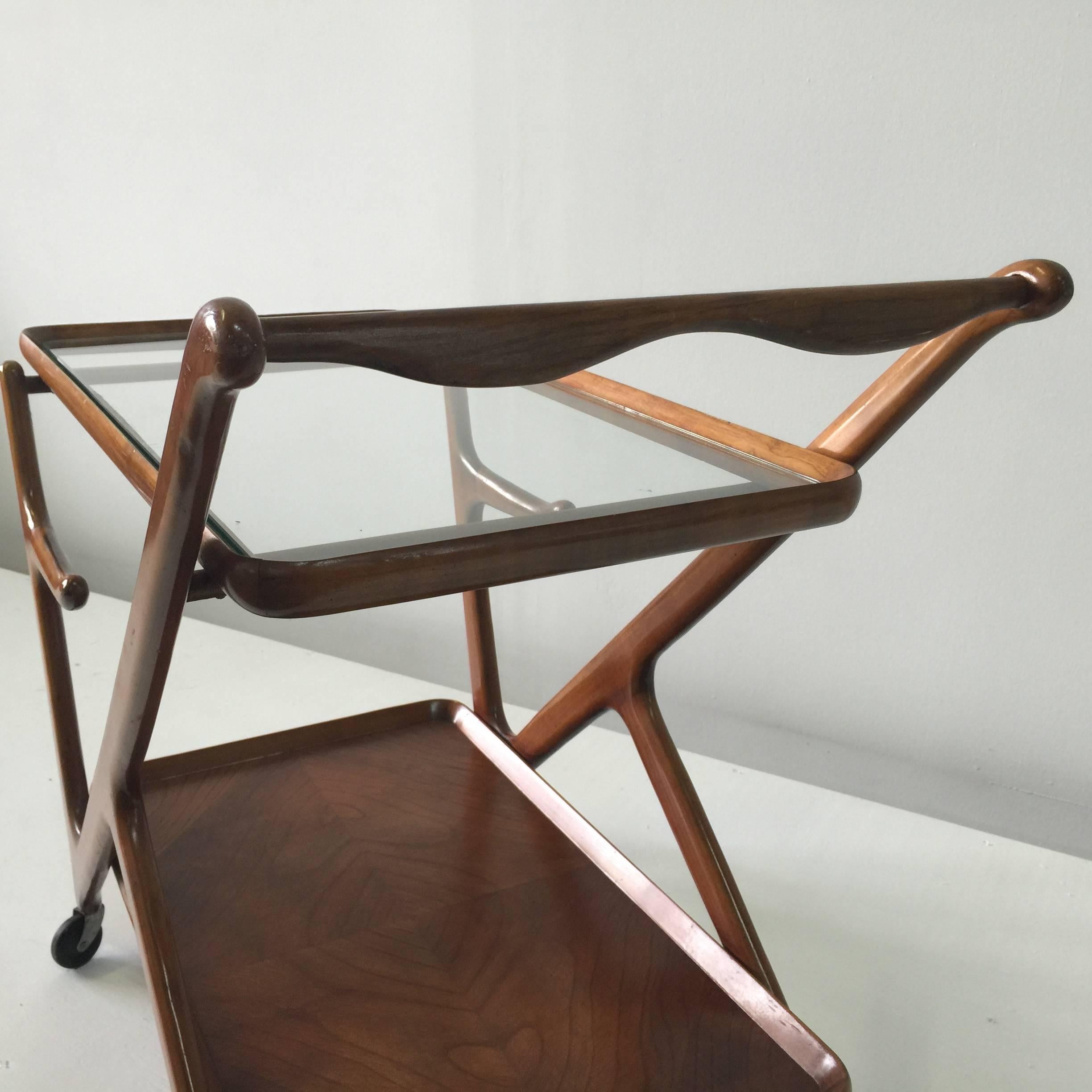 Solid walnut wood bar cart designed by Cesare Lacca for Cassina in 1951. These trolleys are well-known for organic shape and beauty!! All original. The two were found in a Montecatini Villa in Italy, along with other pieces. The two were used as