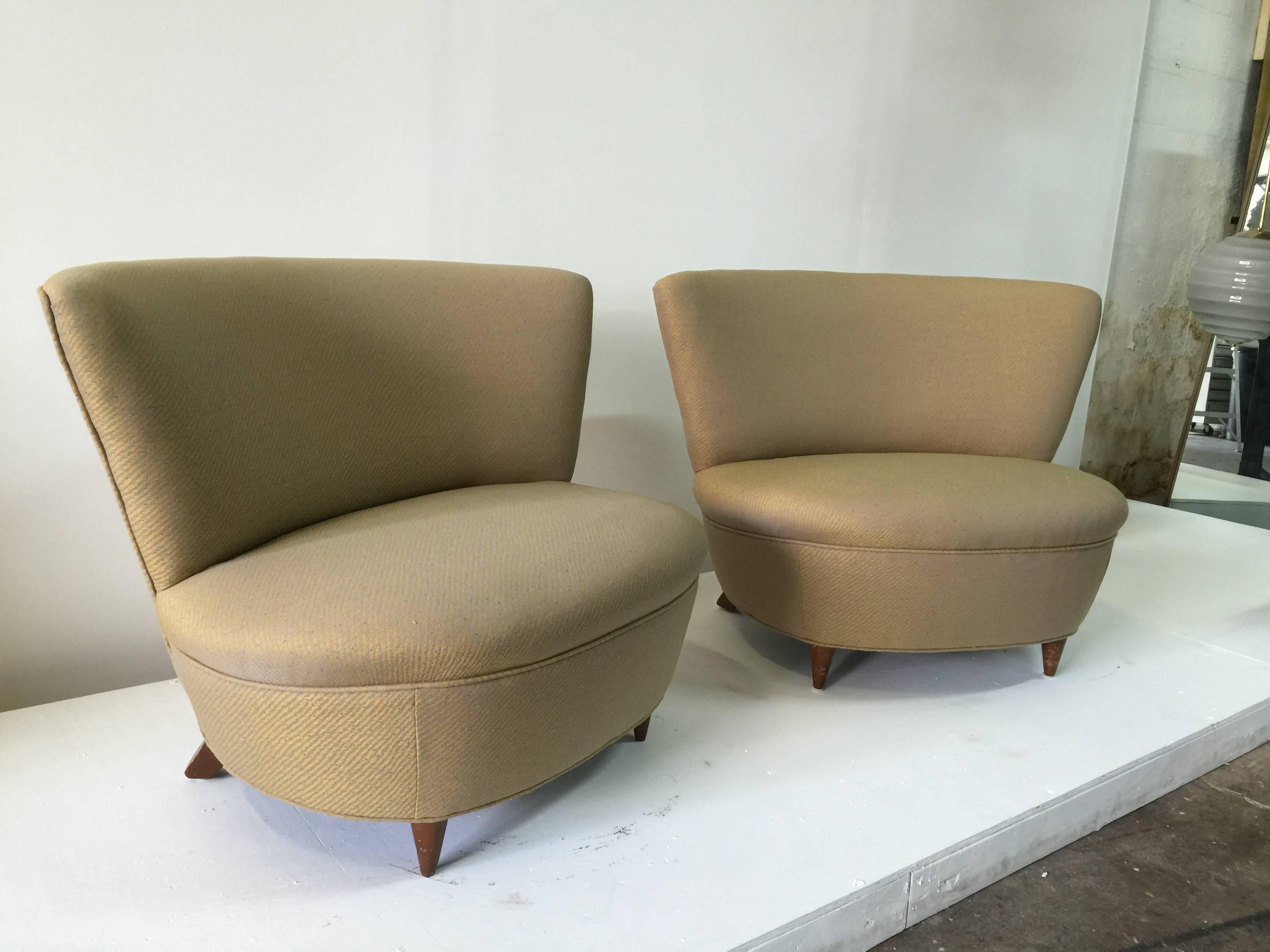 Sleek and iconic, these documented Rohde slipper chairs with wood legs.
