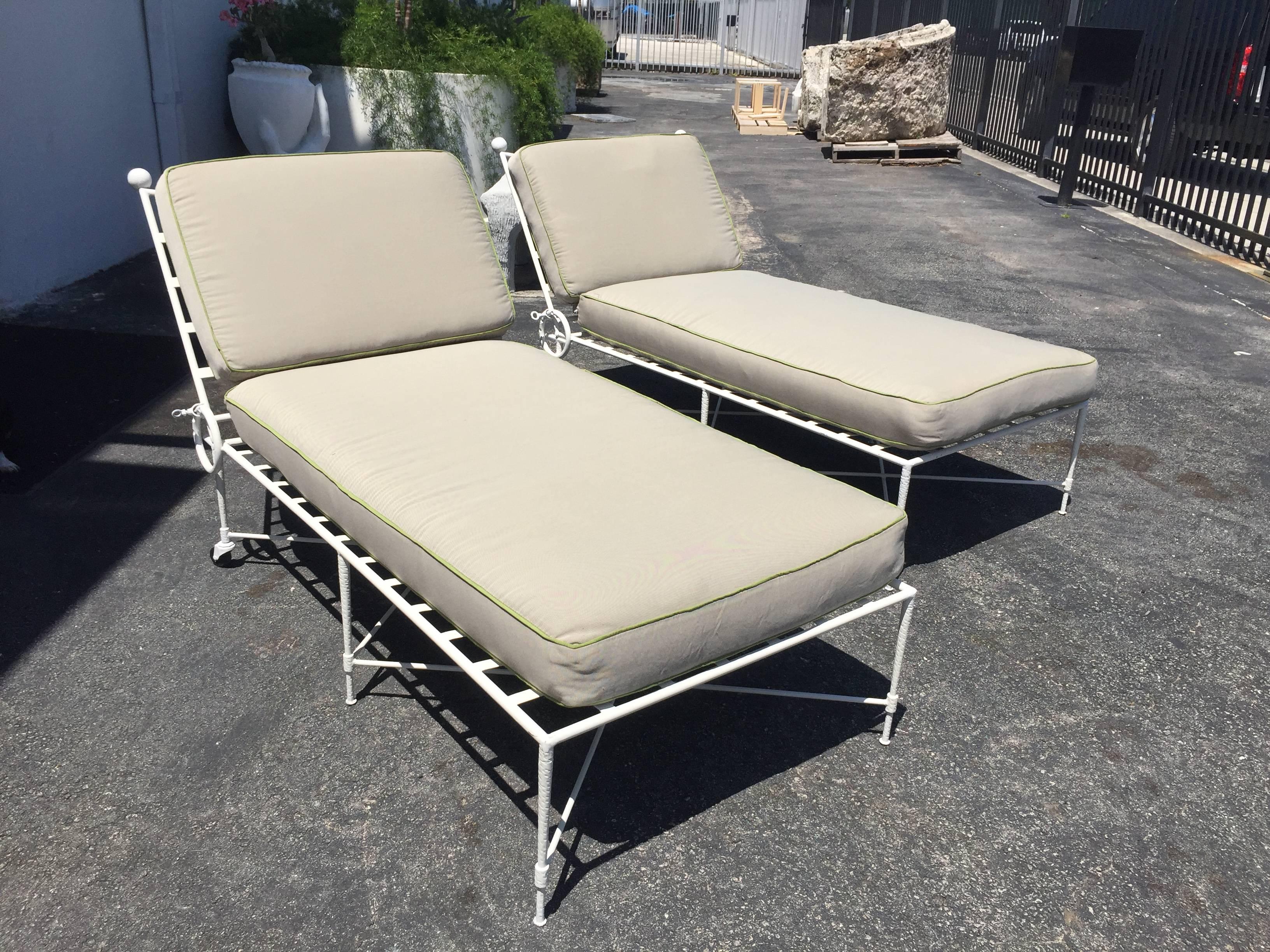 Original reclining chaise longues by Mario Papperzini for John Salterini. Original white painted iron is in excellent condition. Adjustable back reclines from a full 90 degrees upright position to four lower settings to full flat. Cushions shown are