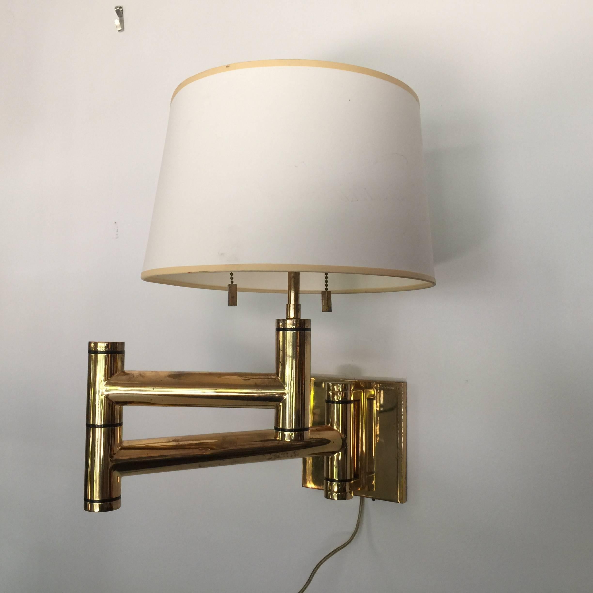 Pair of Karl Springer lamps from 1970s. High quality craftsmanship made in America. All parts including finials, pulls and mounting brackets are original.

27 inches deep when fully extended out - shades are vintage. Back plate measures 6