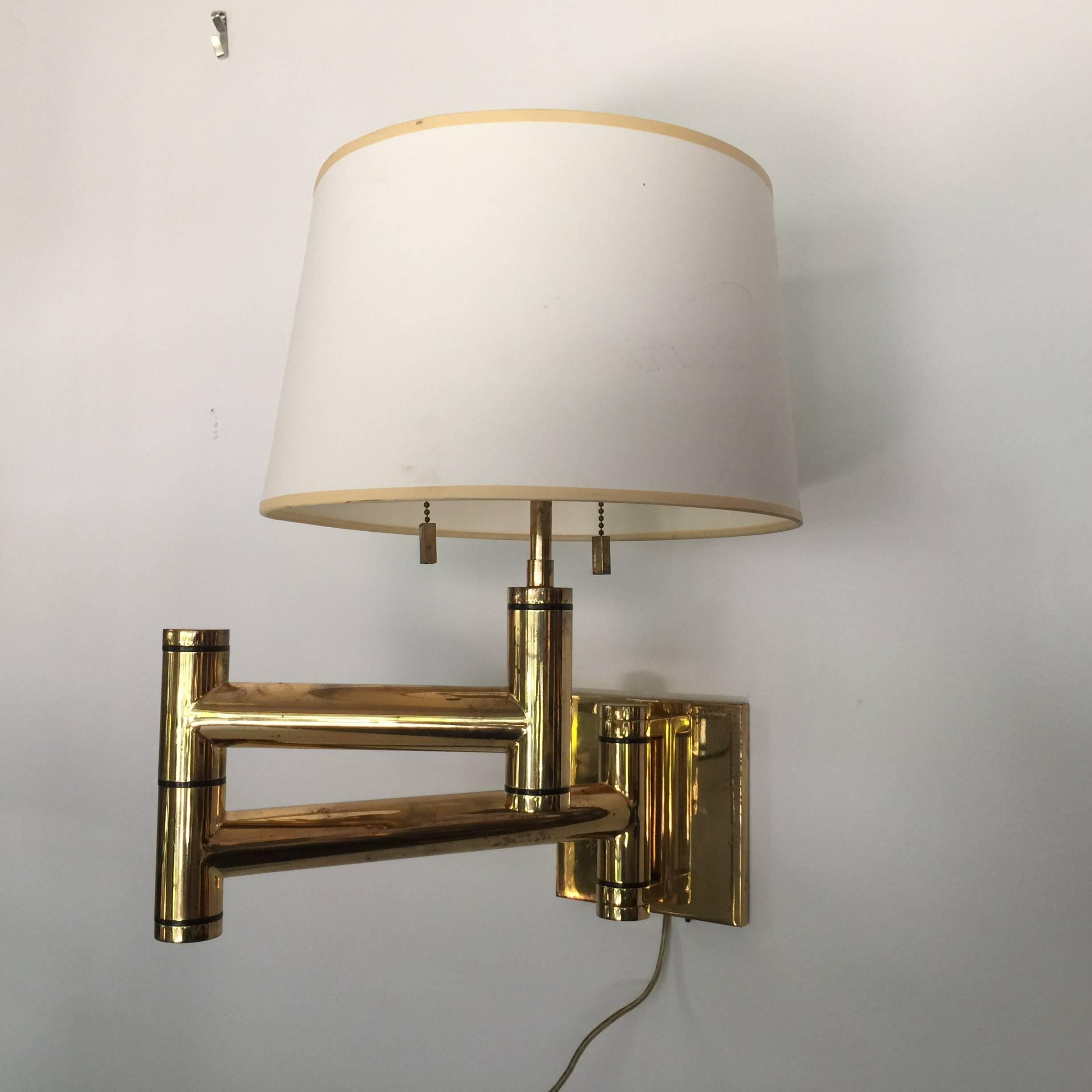 Pair of Karl Springer lamps from 1970s. High quality craftsmanship made in America. All parts including finials, pulls and mounting brackets are original.

27 inches deep when fully extended out - shades are vintage. Back plate measures 6