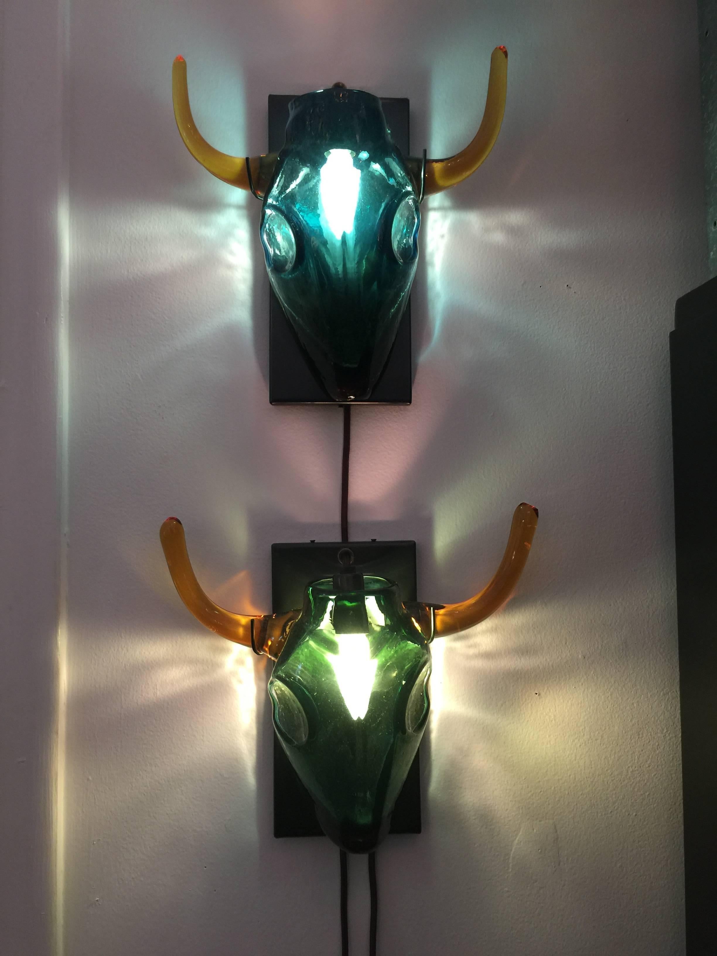 Inspired by Picasso, two of these unique handblown glass sconces are available with slight color variation to the glass. As seen in detail images, one has a slightly green tint and the other blue tint. Recently rewired, UL listed. 

Back plate
