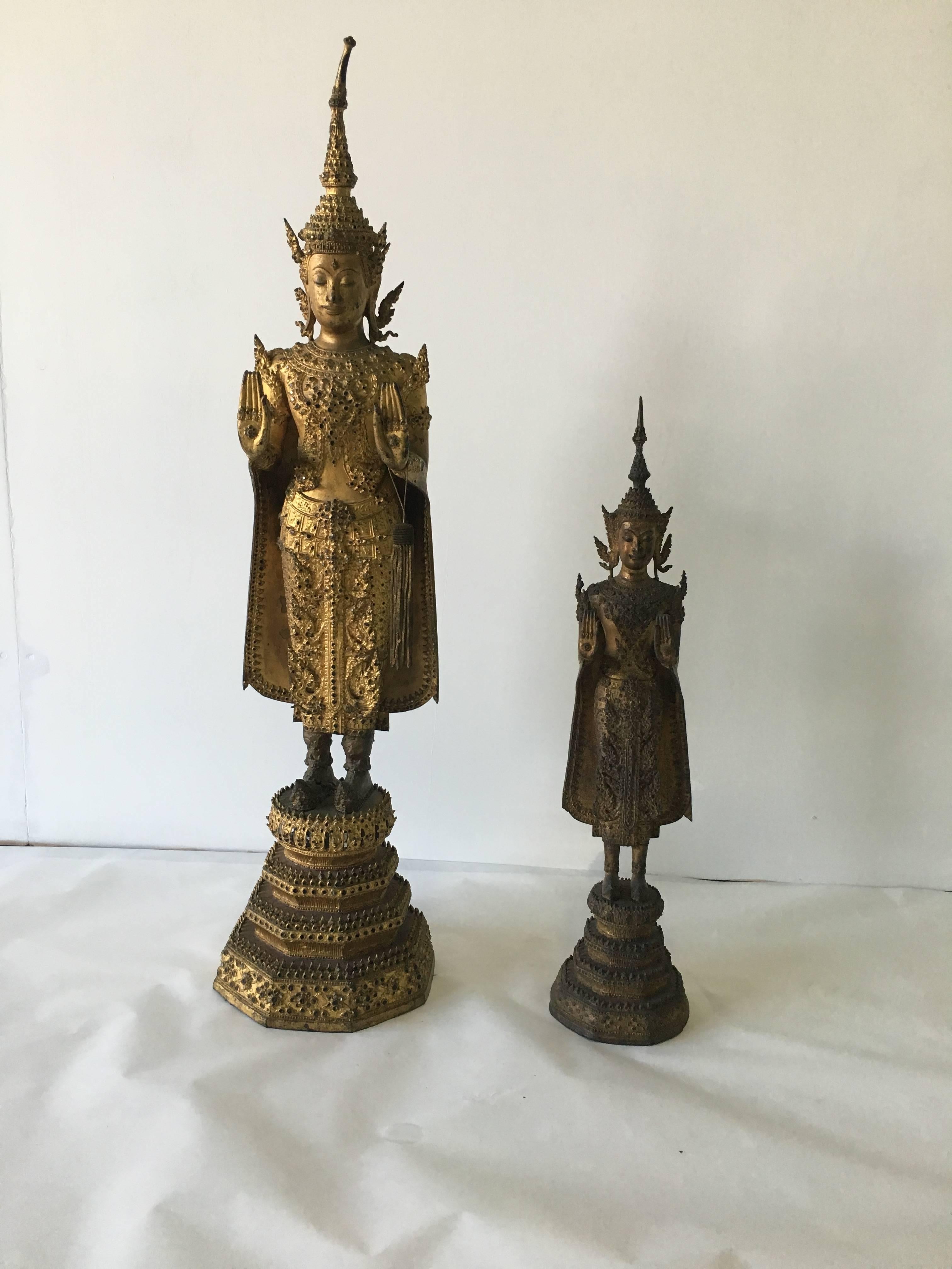 Late 19th century - beautifully preserved coloring.

Dimensions of taller: 33 inches tall (price $4,600).

Dimensions smaller: 22.5 inches tall (price $3,300).

This Buddha in standing position was executed in a typical Laotian style, which