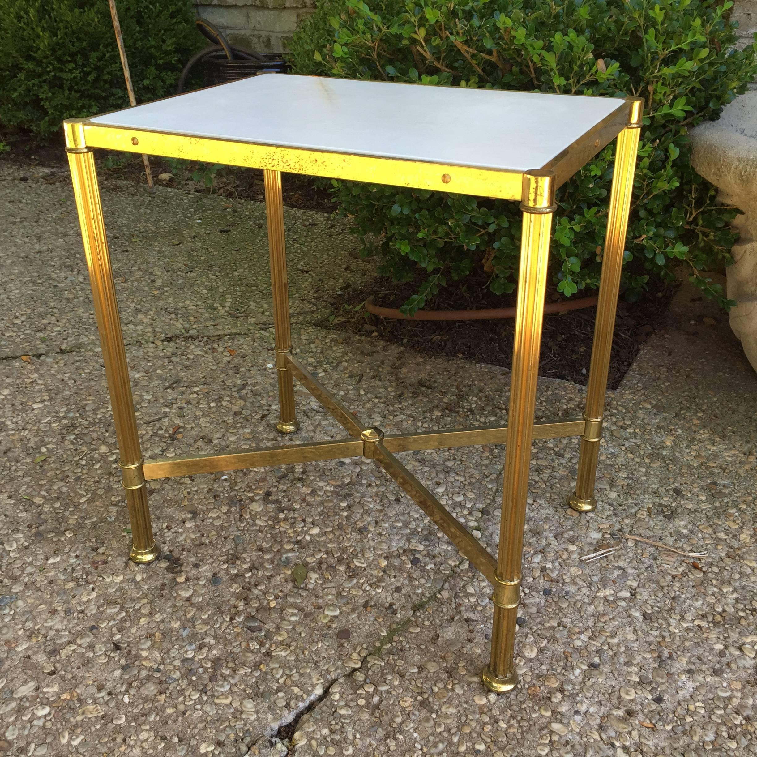 This lovely Jansen attributed brass framed table with a natural parchment top in neoclassical style. It is a wonderful side table.