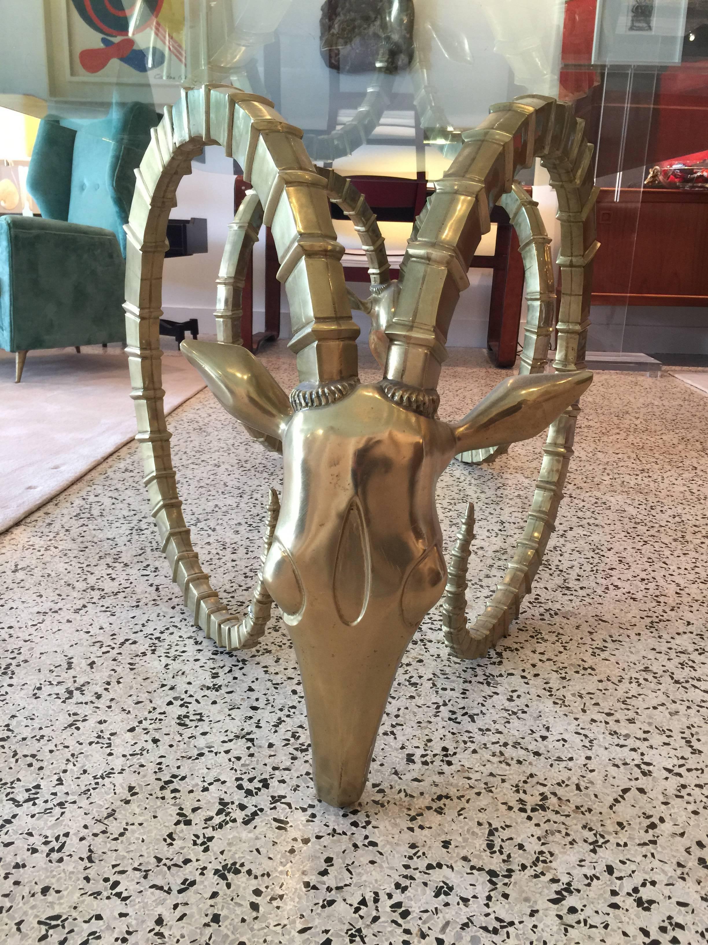 Sculptural table designed with oversized Ibex or ram's heads, attributed to Alain Chervet.  Original large 3/4 inch glass top is INCLUDED (glass does have scratches throughout the top from use, normal wear - NO chips or breaks).   Dimensions of
