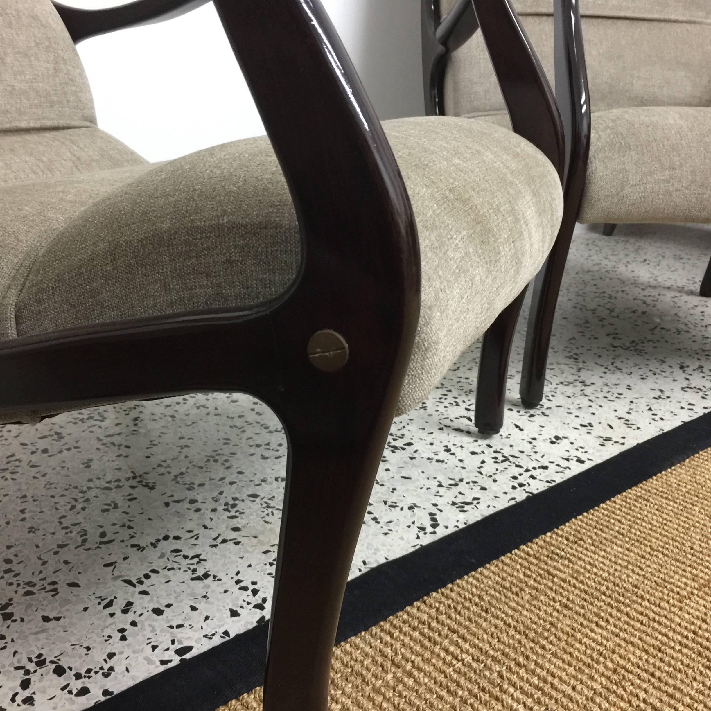 Bentwood armchairs with new upholstery, designed by Ezio Longhi for Elam, feature antiqued solid brass bolts and buttons to sides.