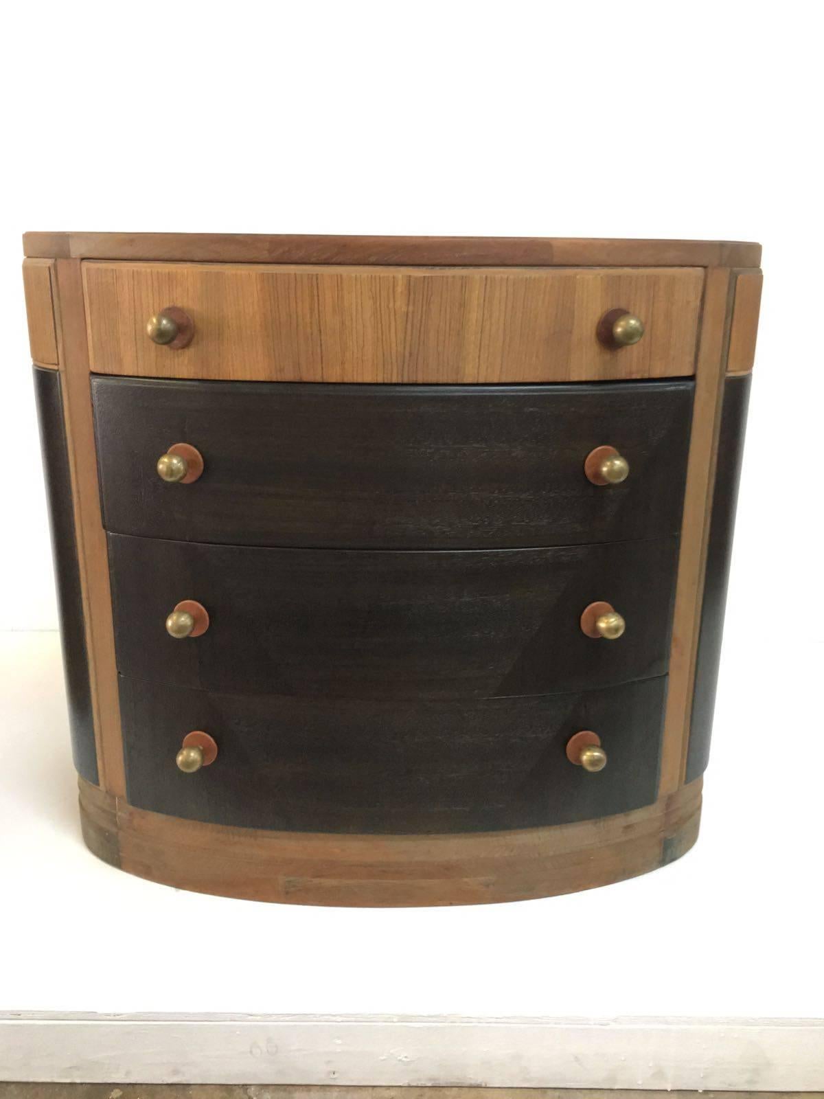 Brass and leather trimmed pulls on these fabulous veneered demilune gentlemen's cabinets or nightstands. Four drawers for ample storage and two tones with great detail of the wood work.