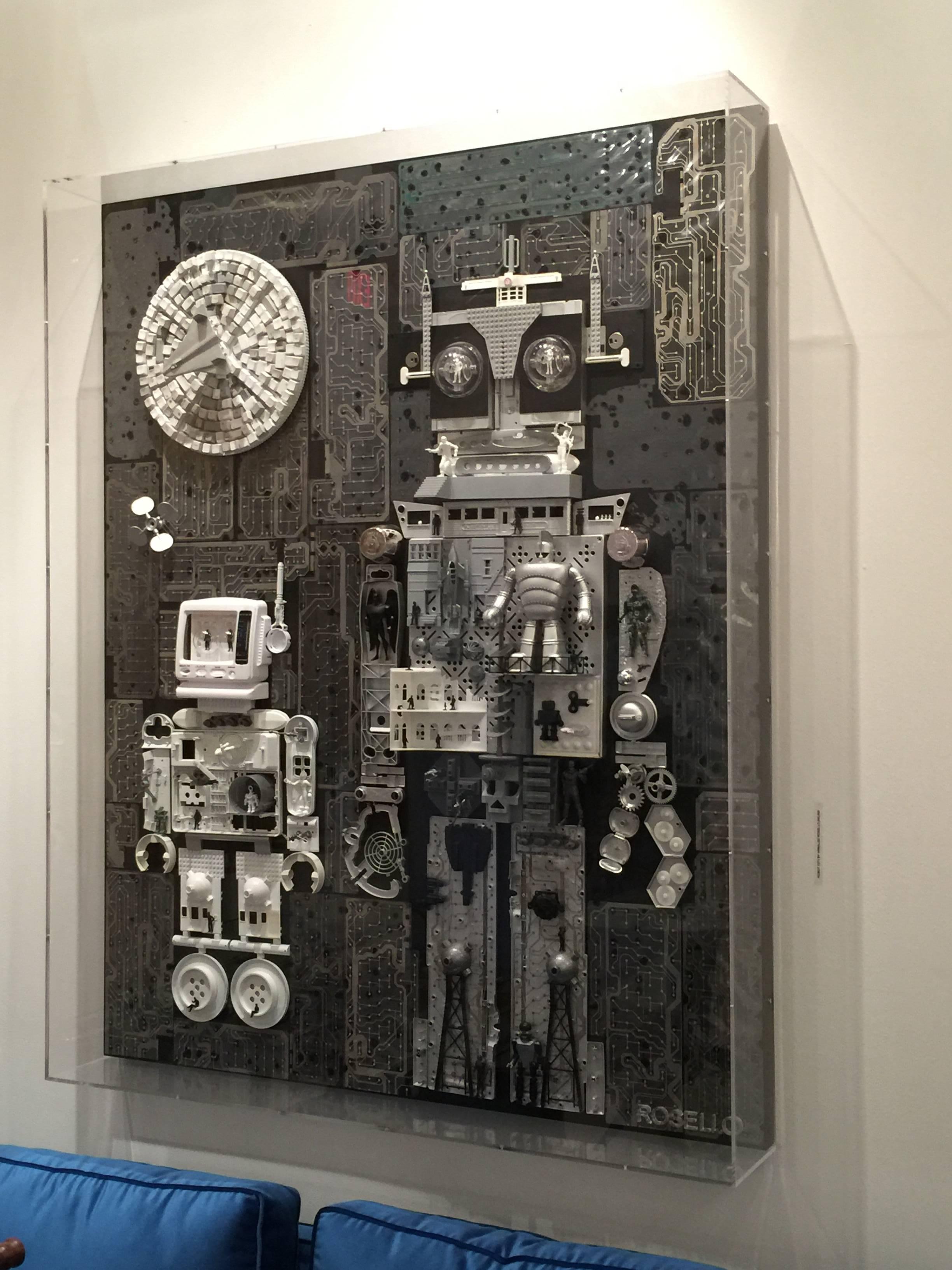 Upcycled computer parts (mother boards, keyboards, etc), vintage toys and unique elements - this is a large wall sculpture beautifully encased in Lucite box. Artist is a Miami native named Rosello.

This wonderful boxed sculpture is