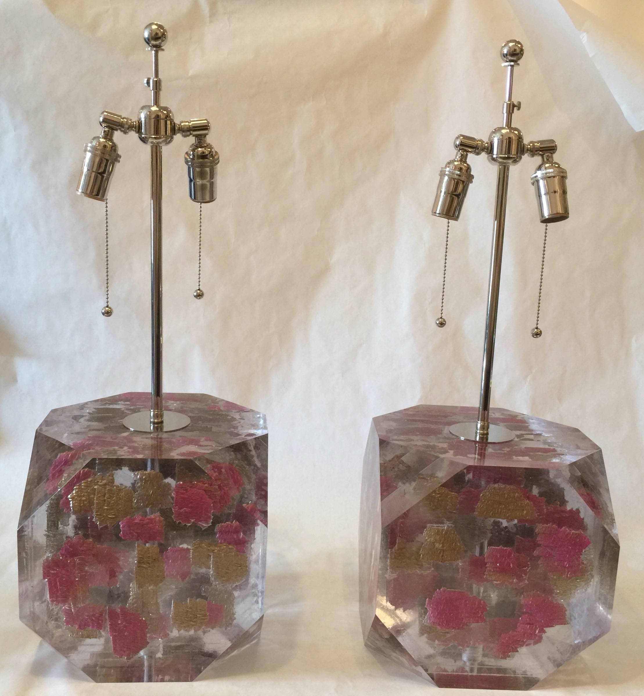 In hues of pink and gold layered within these Lucite sheets, these table lamps are very heavy and quality crafted. Double cluster sockets and nickel pulls, silk wiring. by  Freda Koblick
