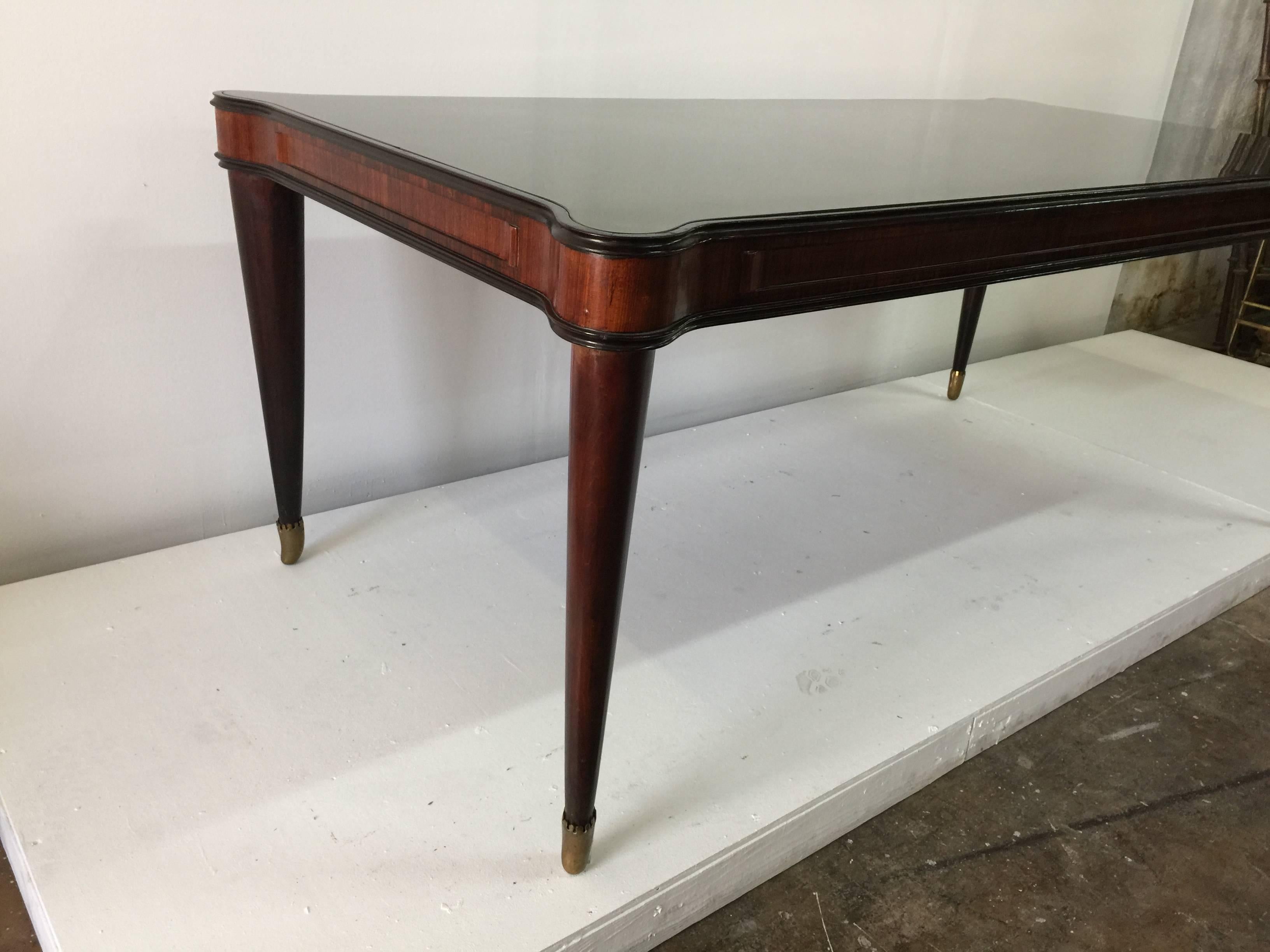 Wonderful reverse painted gold glass plateau with original patina brass sabots. Lovely rounded off corners and rich walnut base.