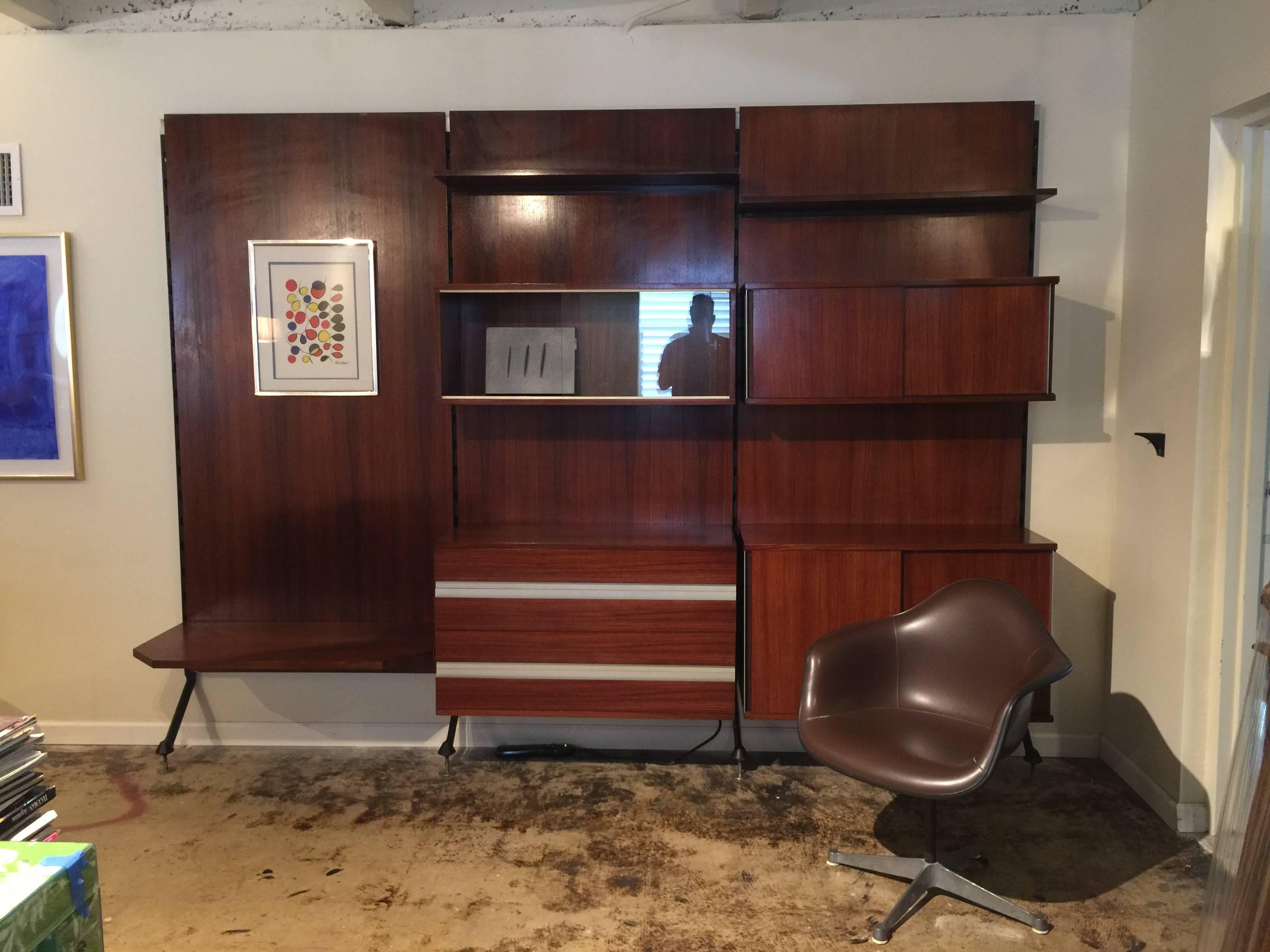 Parisi revisited a project done in 1946 for Arte Casa Cantù, updating materials and production technology for Industrial production required in the late 1950s.
The bookcase is comprised of: three paneled sections, three shelves, one chest of