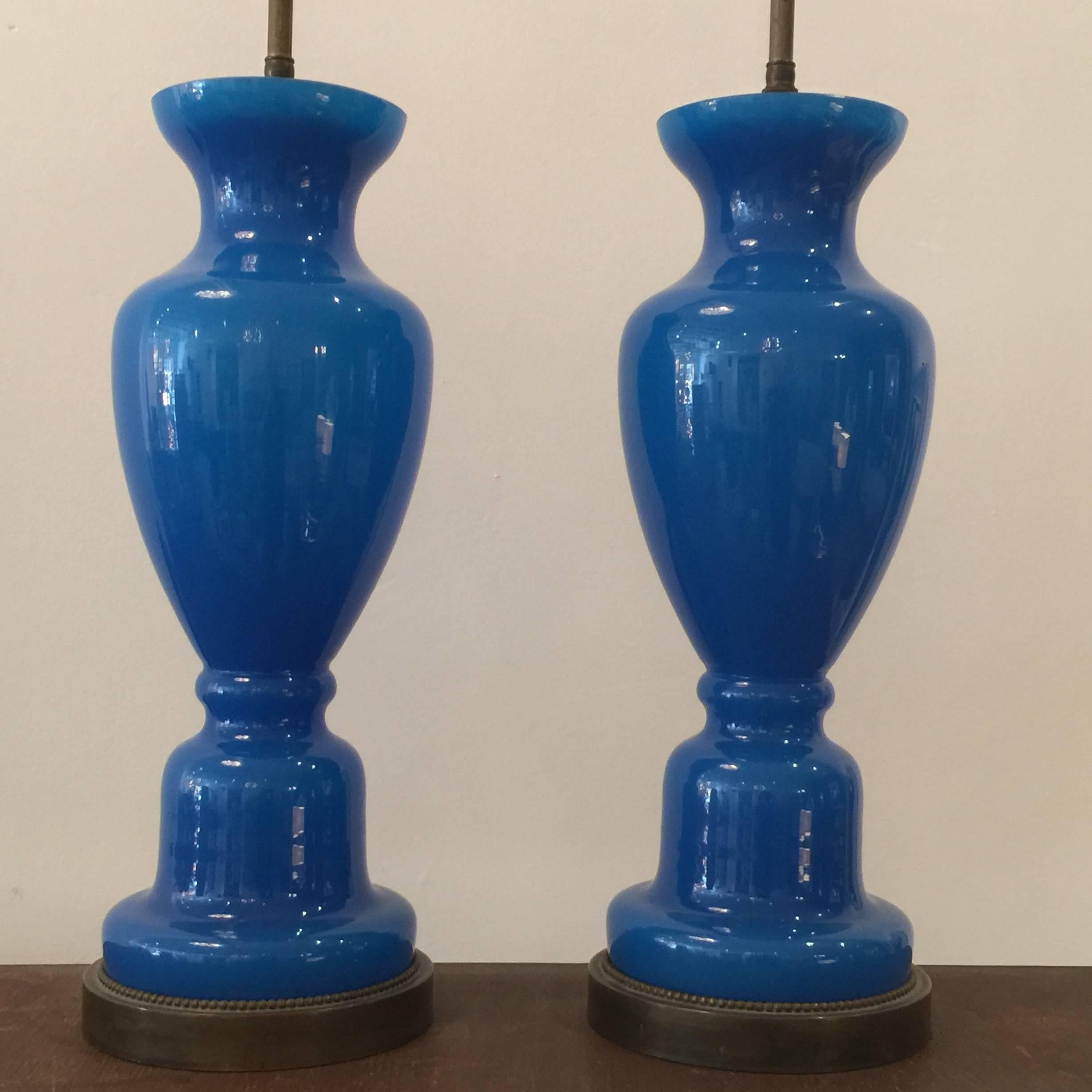 In a Classic urn design, these stunning blue French opaline lamps are vintage and all original. Dimensions of glass only = 19 inch tall.