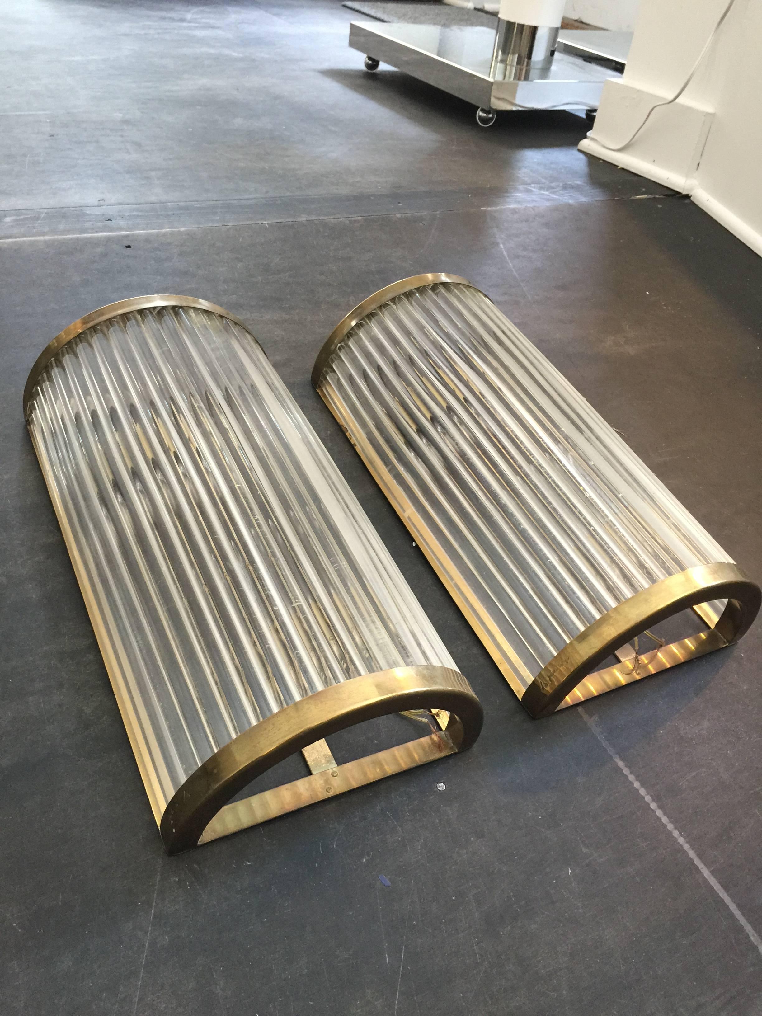 Rare pair of original ribbed acrylic and brass trim frame large wall sconces; These wall lights are designed by Gabriella Crespi in the 1970s, and they are signed to brass frame.