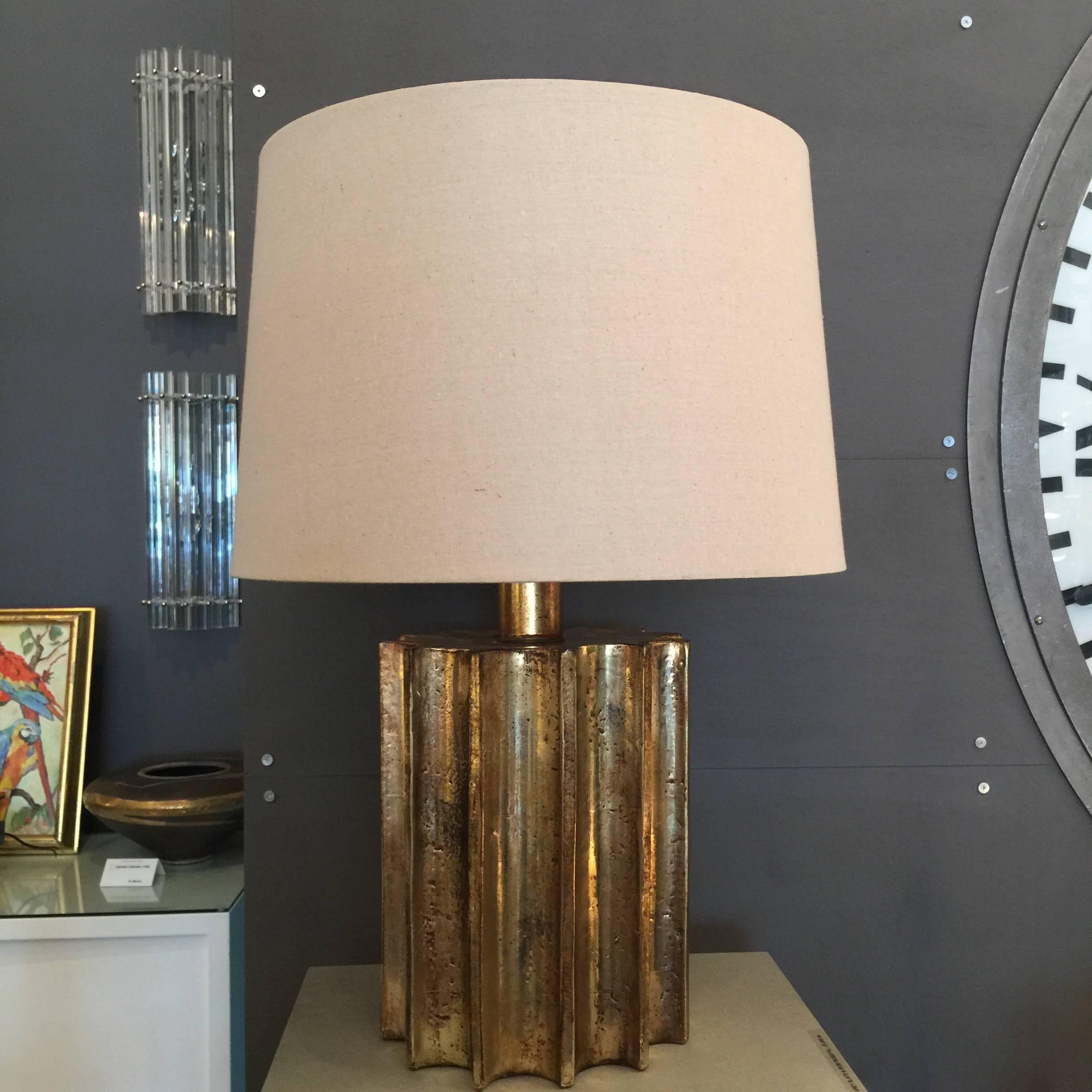 A gilt bronze finish with beautiful patina in gold - this heavy lamp by Chapman is in a mechanical gear design. Shade is new and included.