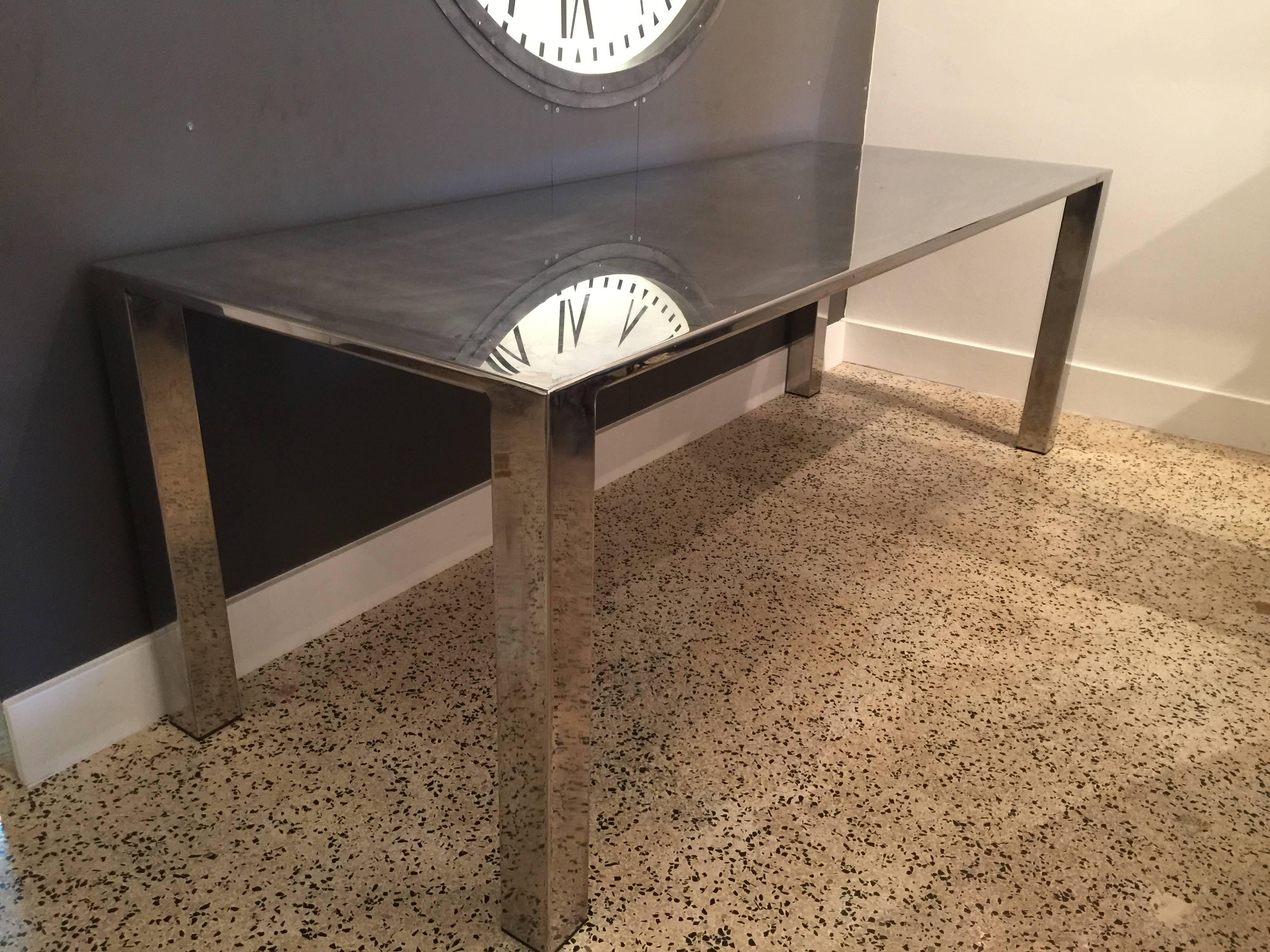 This long and vintage table is perfect for dining, desk or library piece. All stainless steel it is one piece.
