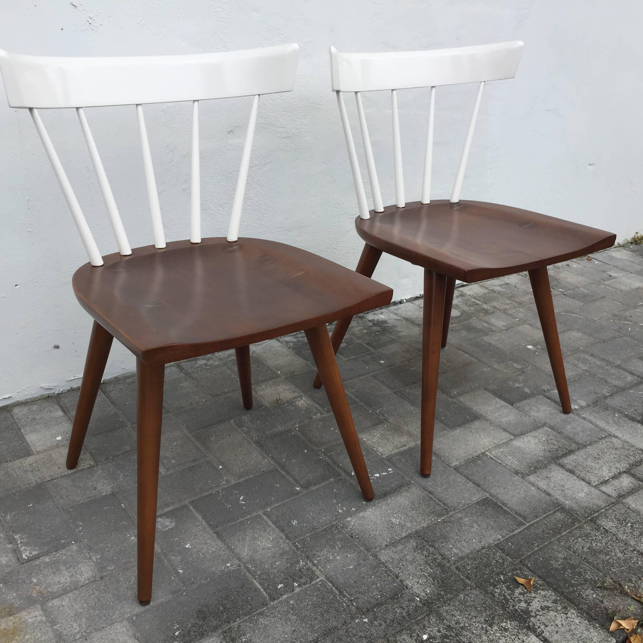 This is a pair of two-toned, white and brown stained wood, Planner chairs designed by Paul McCobb. There is a second pair of McCobb chairs in similar two-tone that would complement beautifully as a set of four chairs. See detailed images.