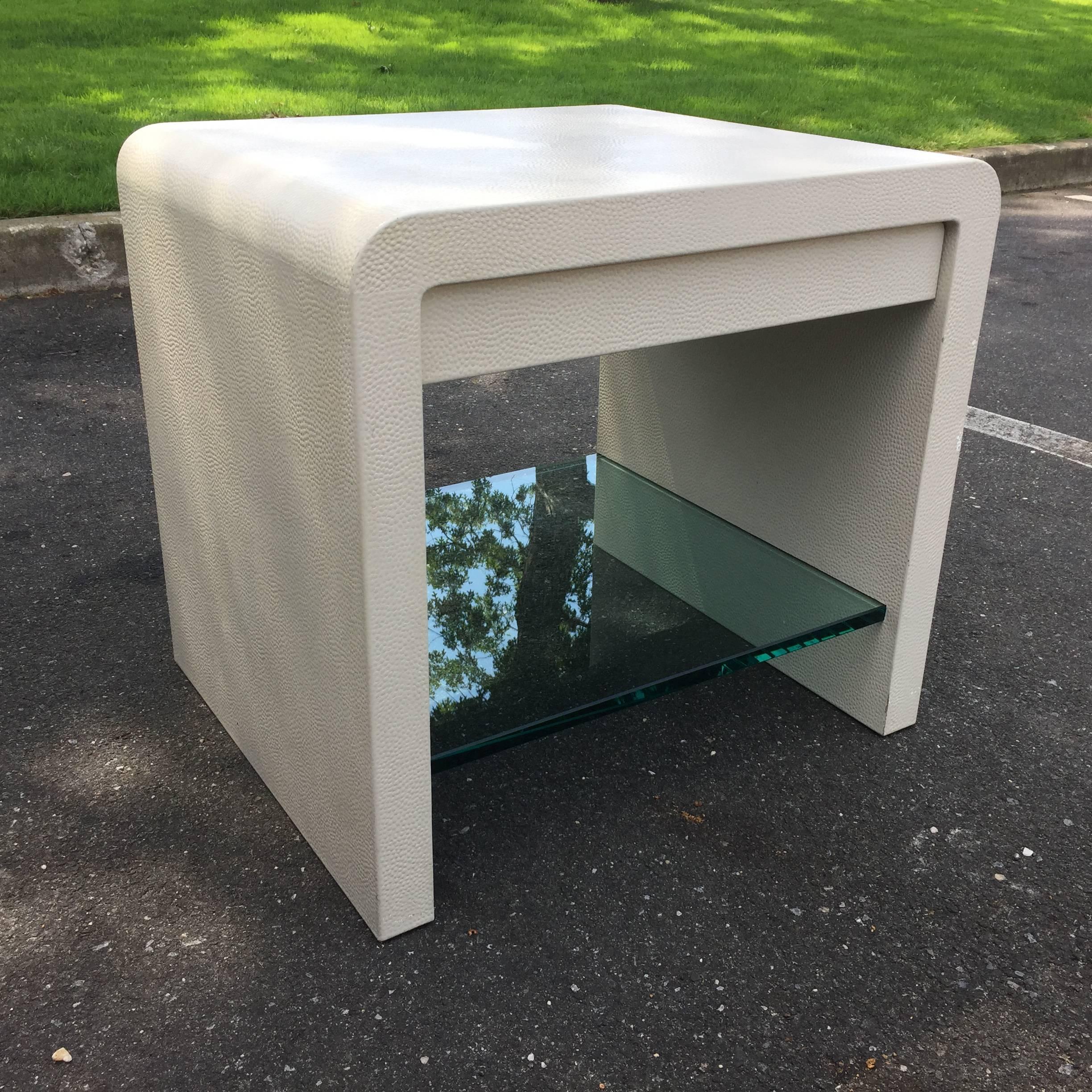 This iconic and rare waterfall design vintage side table by Karl Springer features a recessed drawer and 3/4 inch thick glass shelf (chip to glass on backside - not visible). Can be replaced at additional cost.

Label embossed to underside Karl
