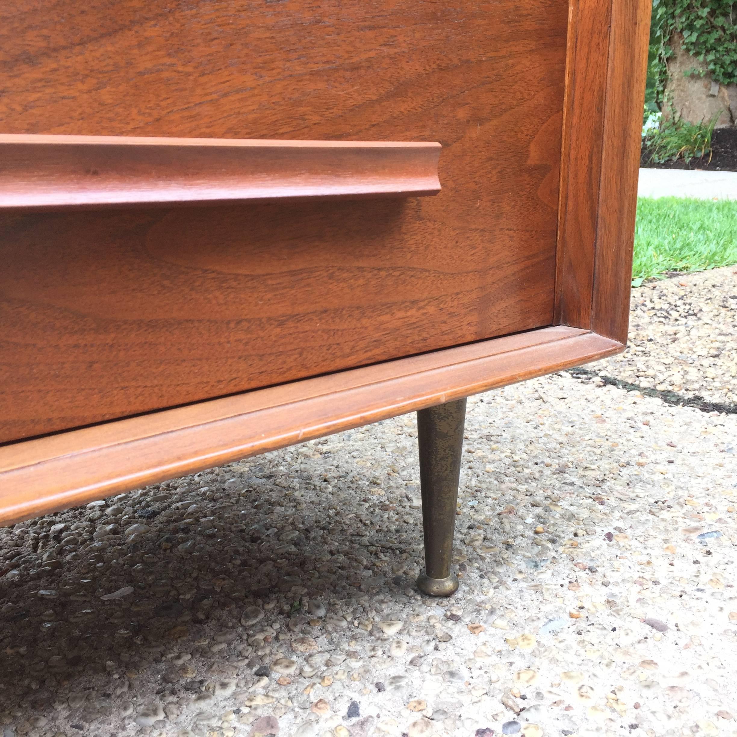 Beautiful tapered brass legs on this well-proportioned masculine dresser with three drawers. Very much in spirit of Gio Ponti.