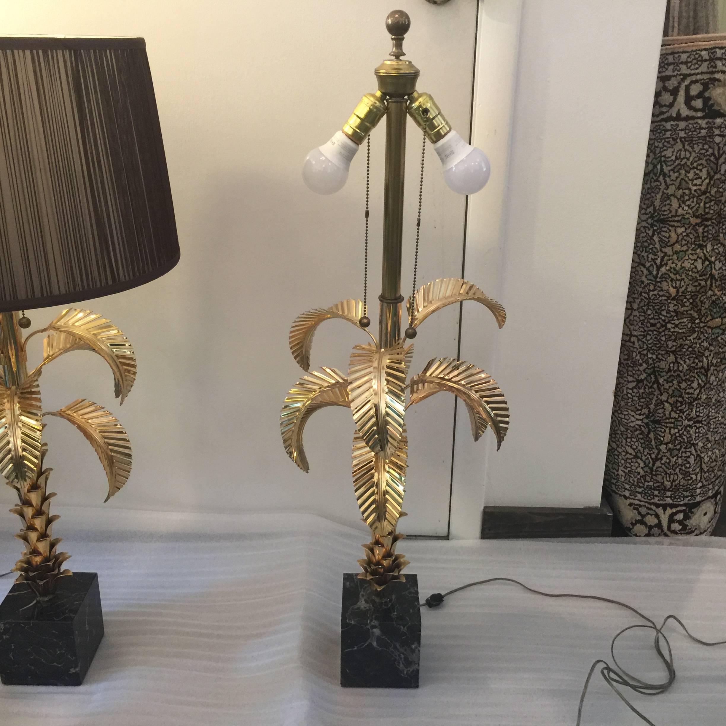 Mounted on black marble, these exceptionally detailed gold-plated on metal table lamps in style of large-scale palm trees. Pleated brown silk shades not included (sold separately). Double sockets.