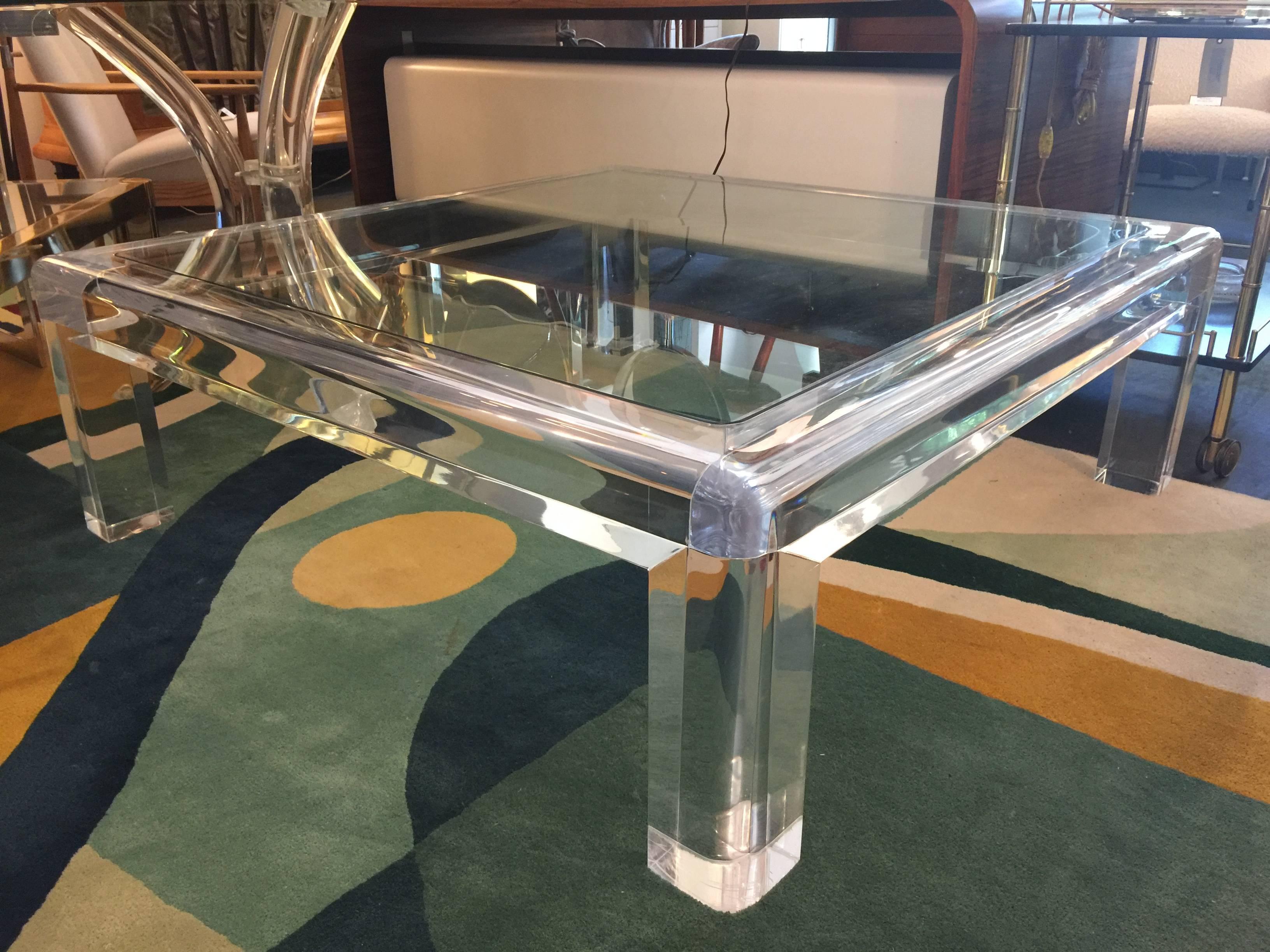 An amazing clear acrylic and glass oversized cocktail table by Les Prismatiques (marked). This significant table is constructed of thick clear acrylic with a 1/2" thick inserted glass top. The frame is 3 1/2 inches of perfectly clear Lucite.