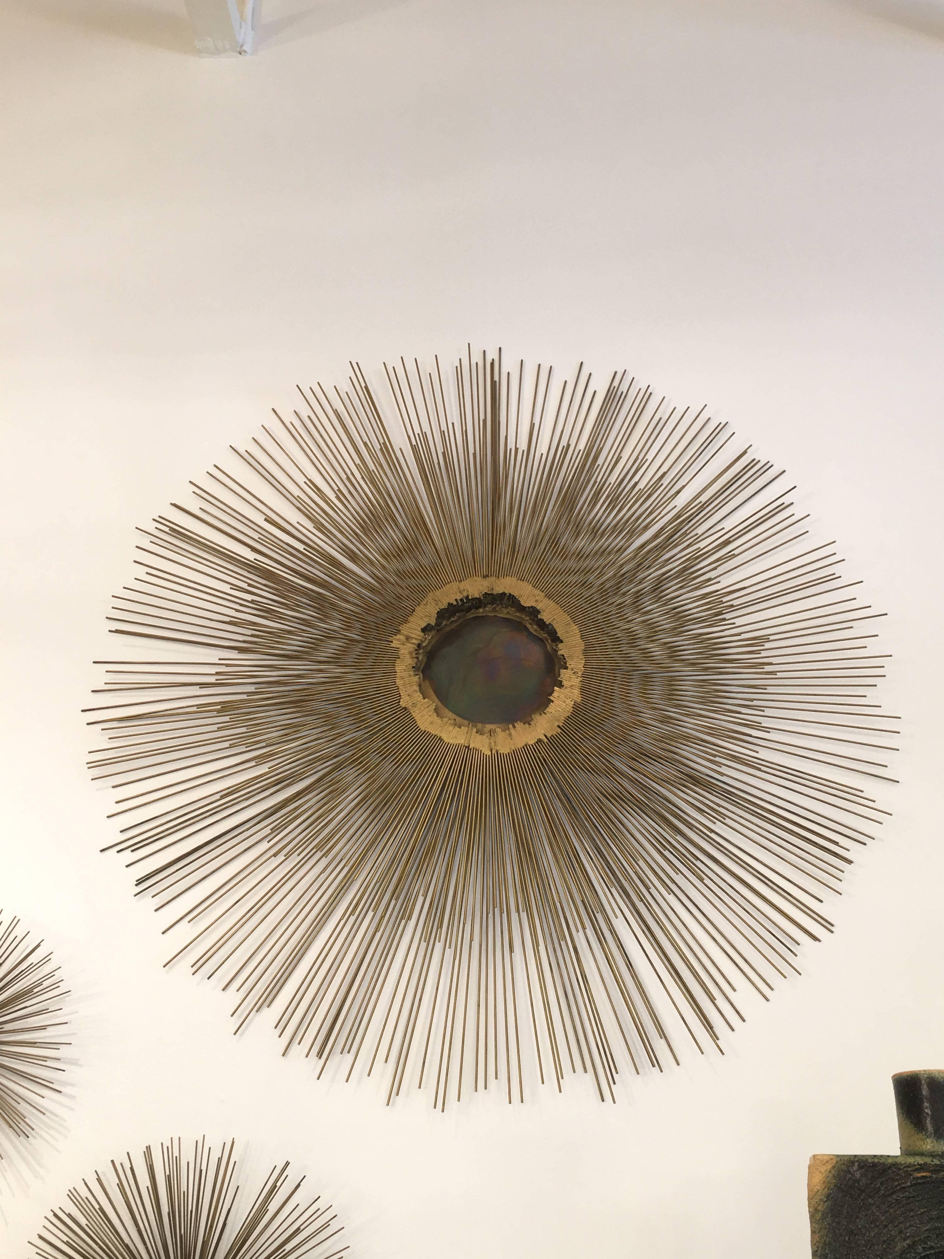 Sculptural set of large vintage brass wall-mounted art - the largest being the sunburst with soldered brass corona. The two-sea urchin design sculptures are of different sizes.

Dimensions: 

Large: Diameter 40 inches, 4 inches deep to wall
Medium