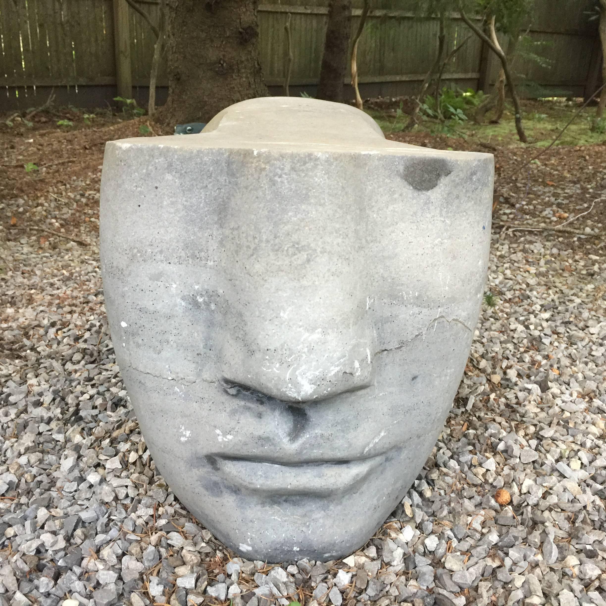 This exquisite stylized Egyptian sphinx is carved of honed grey stone. Sourced from an important Hamptons estate, this sculpture can be used indoors as well as outdoors.