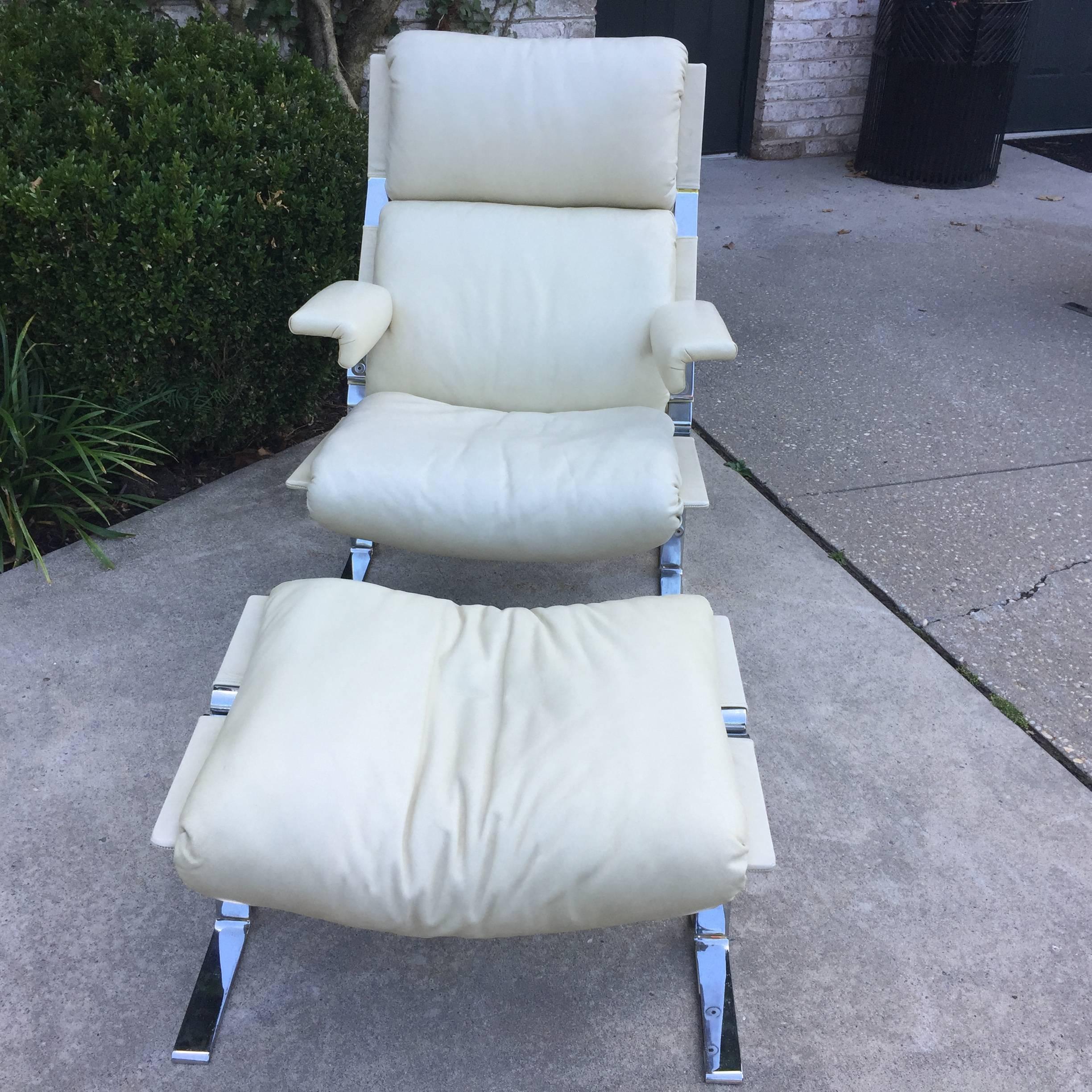 Original ivory leather on this vintage Saporiti lounger and ottoman. Very heavy steel framed and comfortable lounge chair with matching ottoman is made in Switzerland by Saporiti. Ottoman dimensions are: 26 inches wide, 18.5 inches deep, 17 inches