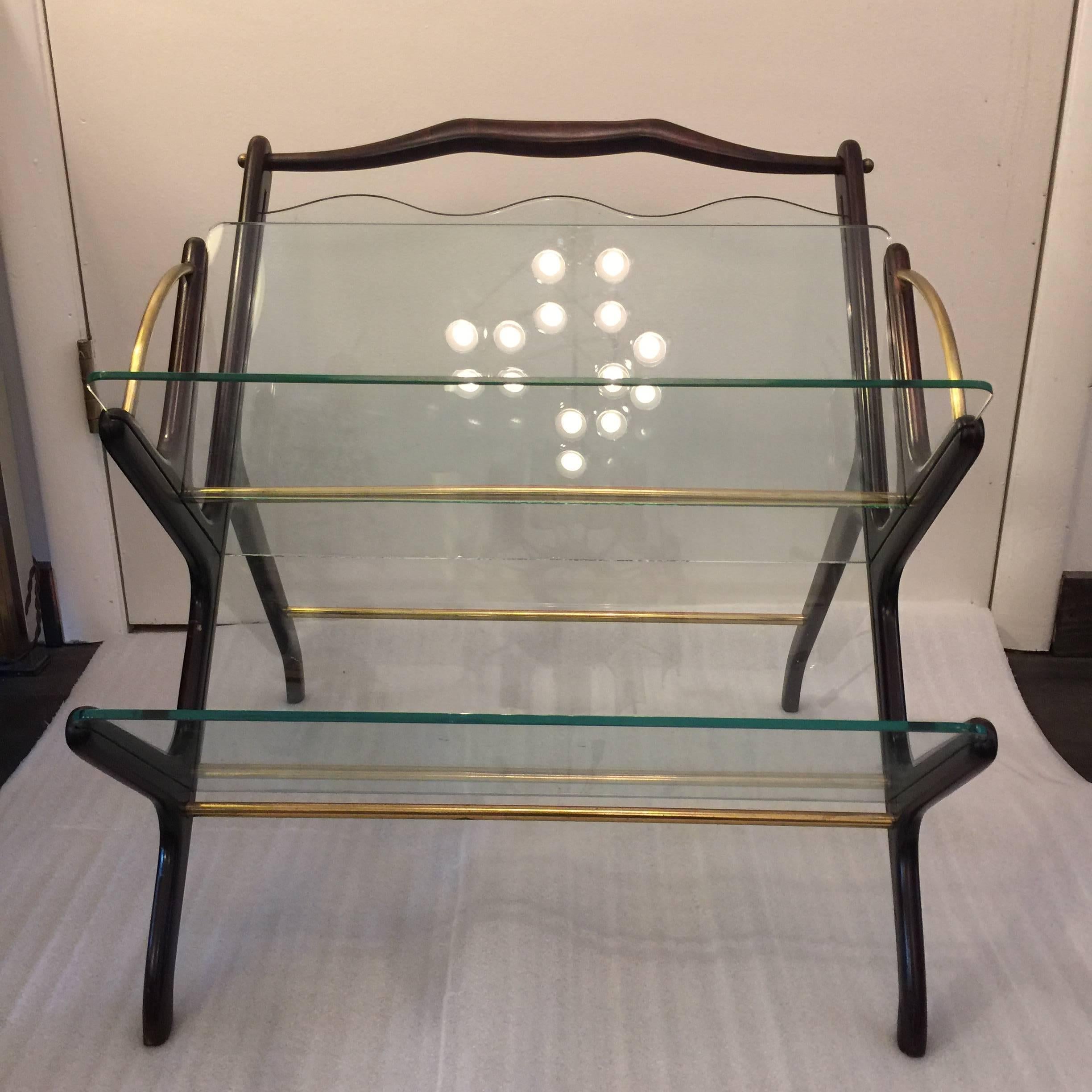 Beautiful organic shaped magazine rack designed and made in Italy in the 1950s, with two glass shelves and one scalloped glass back. All original.

Beautifully crafted Italian design that would perfectly fit the designs by Gio Ponti, Paolo Buffa,