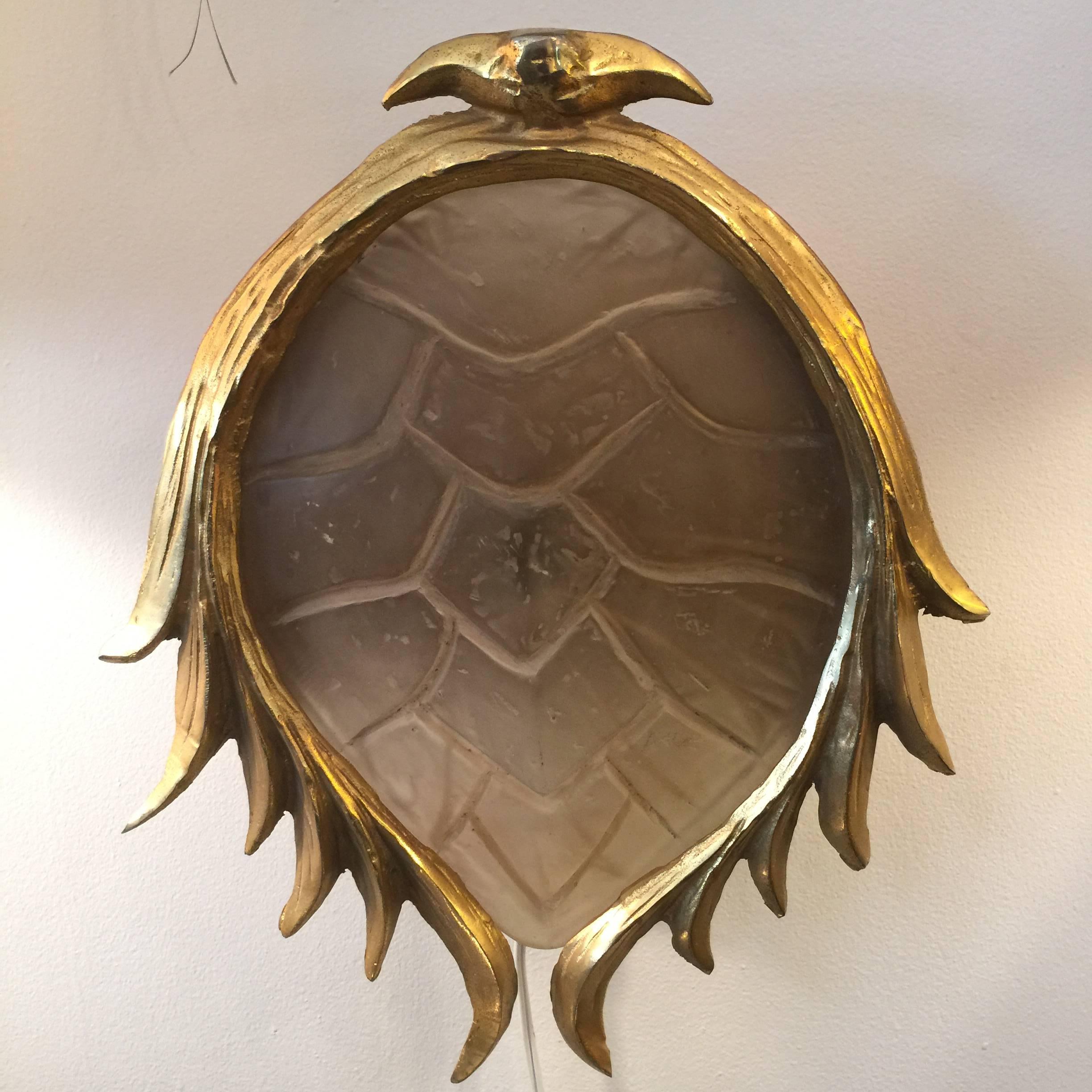In the style of Tony Duquette, this amazing resin tortoise and gilded bronze wall applique has been rewired. This jewel will add panache to any room.

Rewired for US standards. 75W Edison bulb.
        