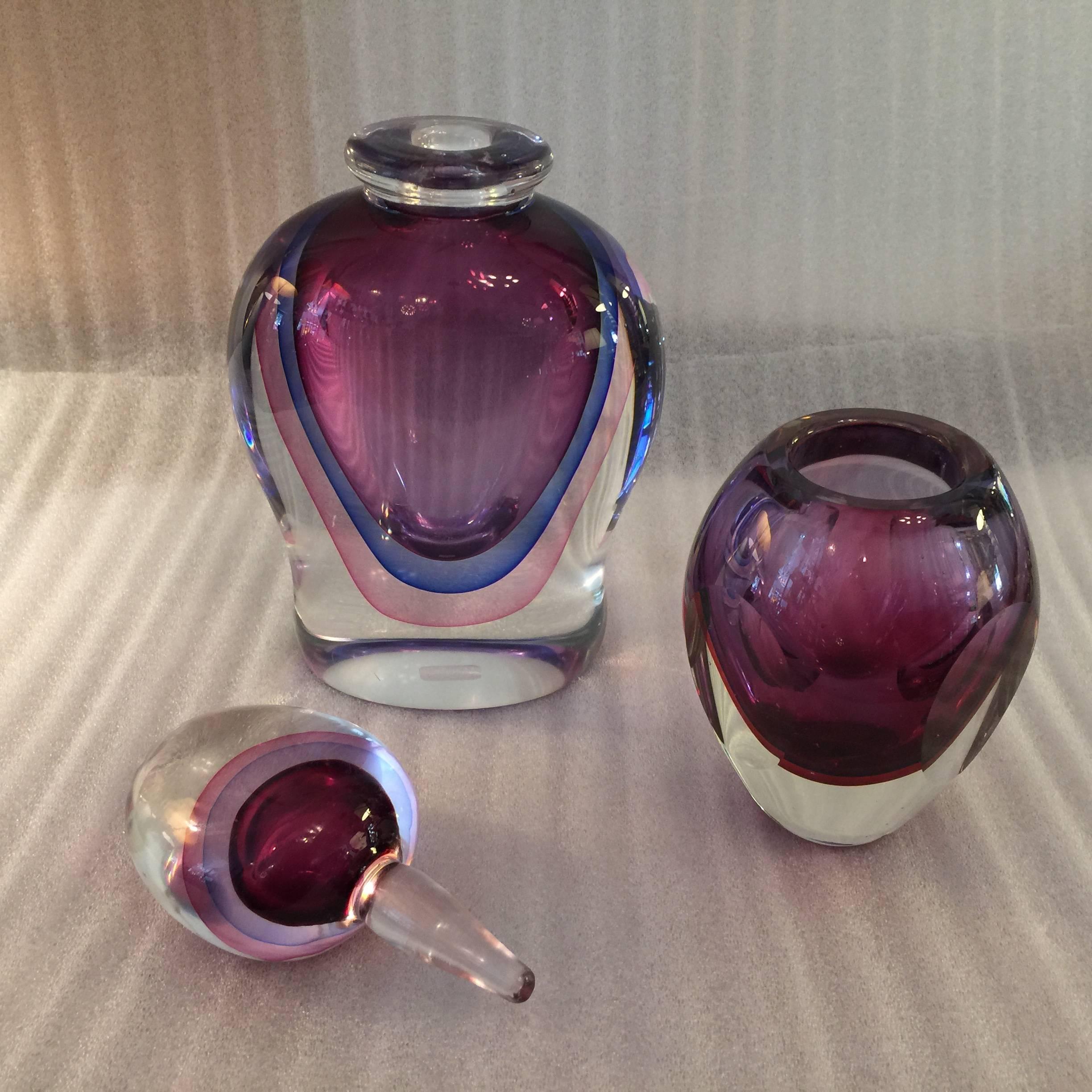 This lovely pair of plum/pink/ blue toned decanter and bud vase by Luigi Onesto.

Vase dimensions: 4 inch D. x 5.5 inch H.
