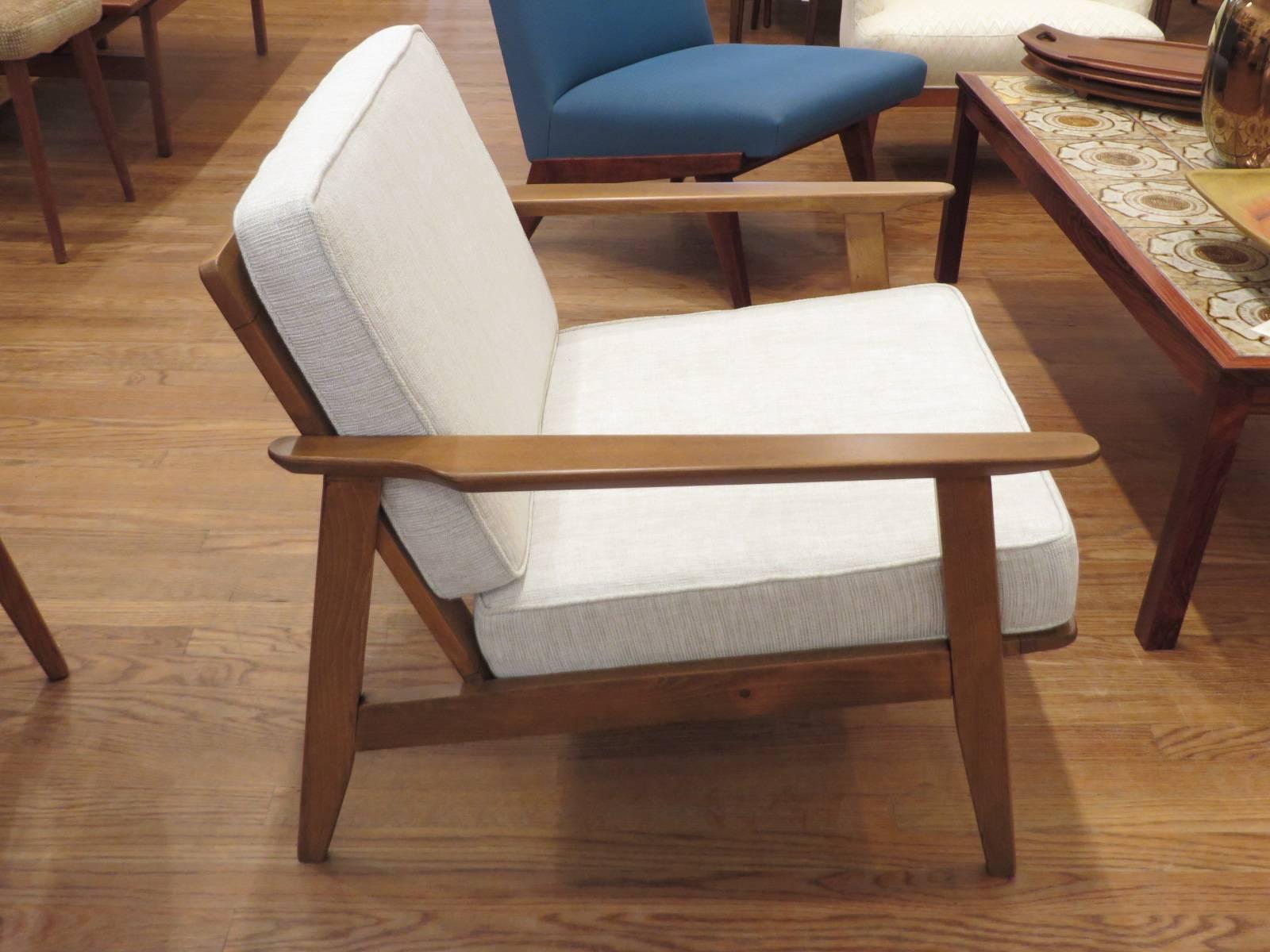 Classic Danish modern armchair newly reupholstered. The chair is very comfortable and perfect for reading or entertaining. Pleasing design will fit into any decor. Great living room or bedroom chair.