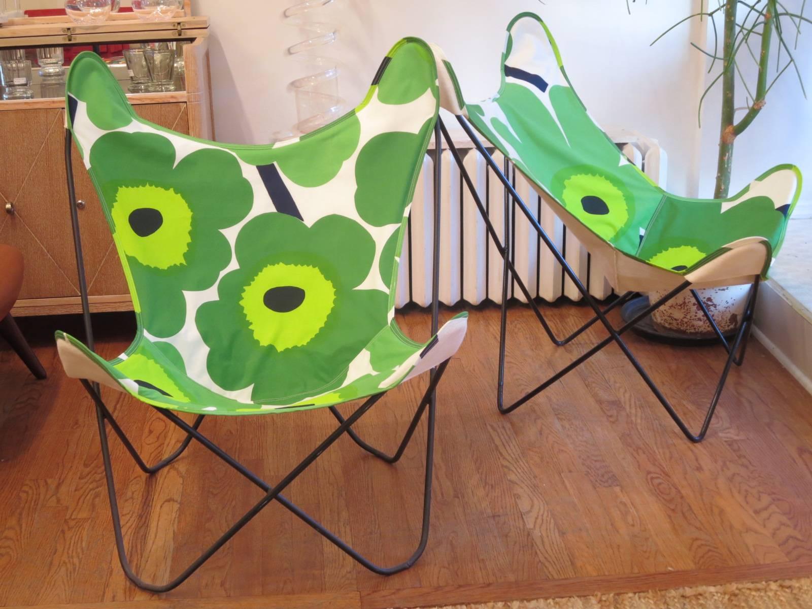Fun and iconic butterfly chairs, newly upholstered in bold Marimekko poppy fabric. Chairs are great for indoors or outdoors. Sling is very sturdy and is backed with linen fabric. Two available.