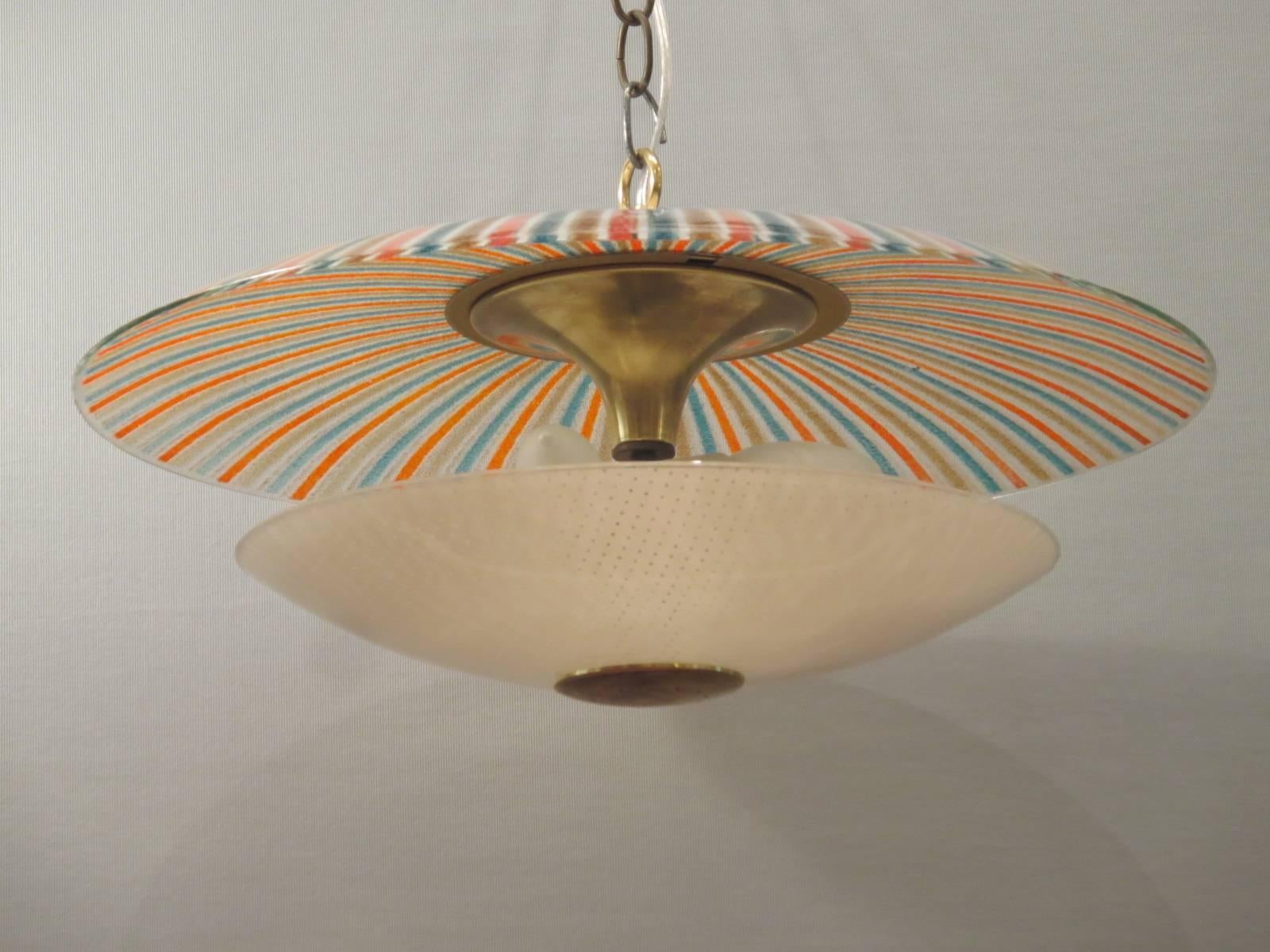 Lovely 1950s light fixture with a striking alternating stripe pattern of three colors as the top part of the fixture with a pierced glass bottom. Both top and bottom are connected with brass. Holds three bulbs. Beautiful when illuminated or not.